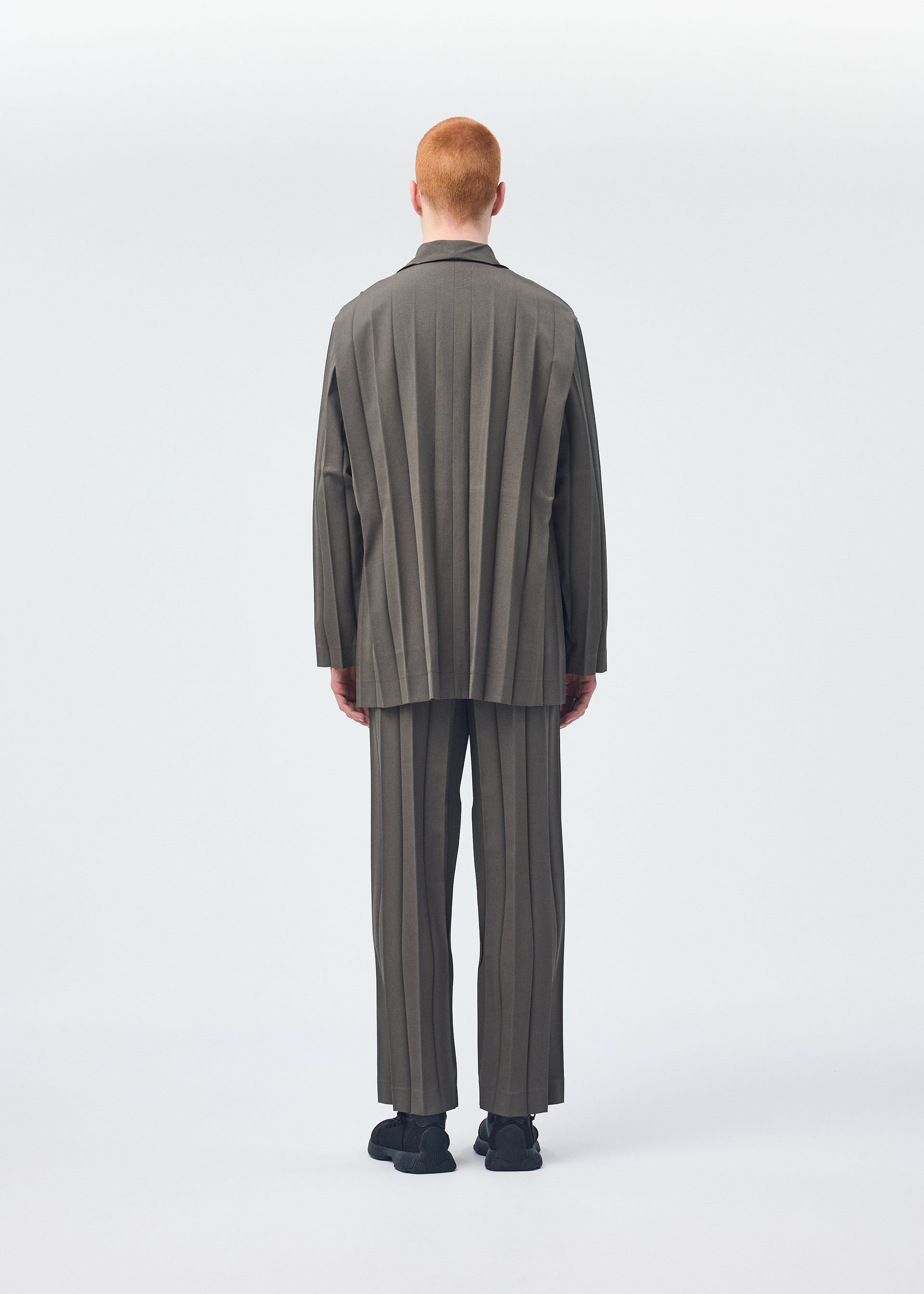 A model wears the HOMME PLISSÉ ISSEY MIYAKE EDGE ENSEMBLE jacket.