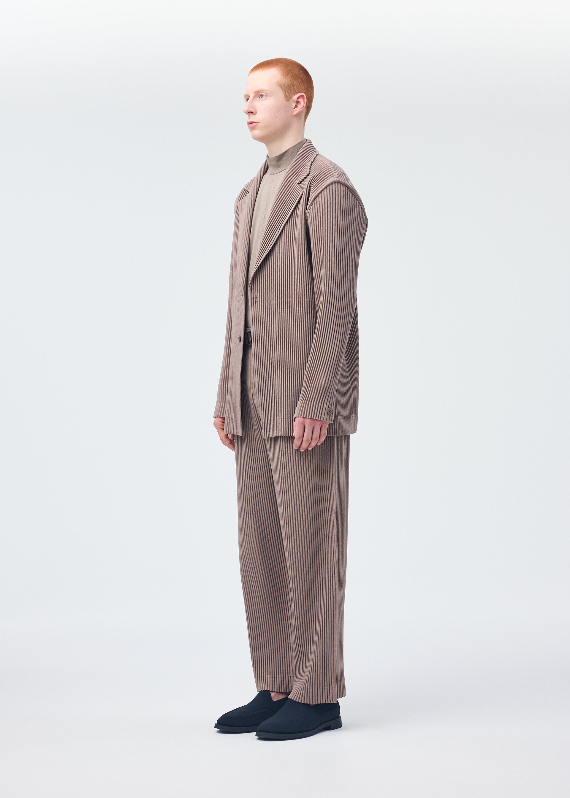 A model wears the HOMME PLISSÉ ISSEY MIYAKE KERSEY PLEATS jacket.