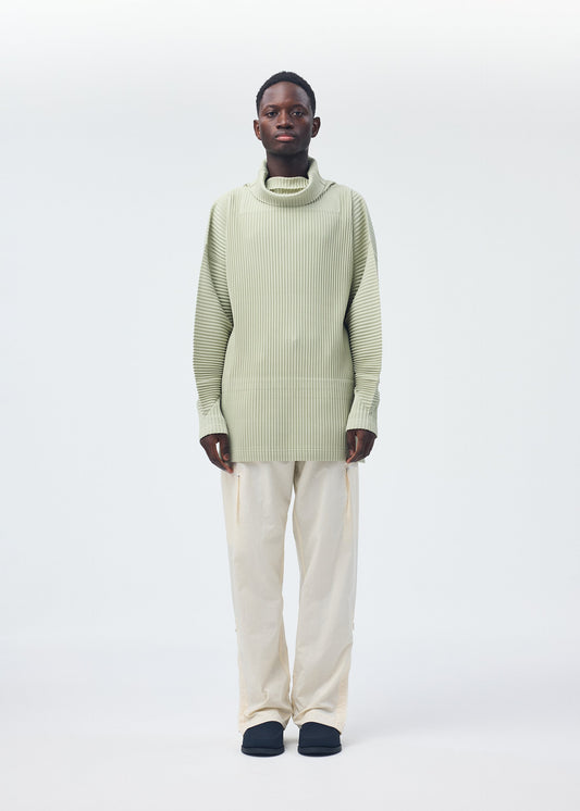 A model wears the HOMME PLISSÉ ISSEY MIYAKE QUARRY PANTS trousers.