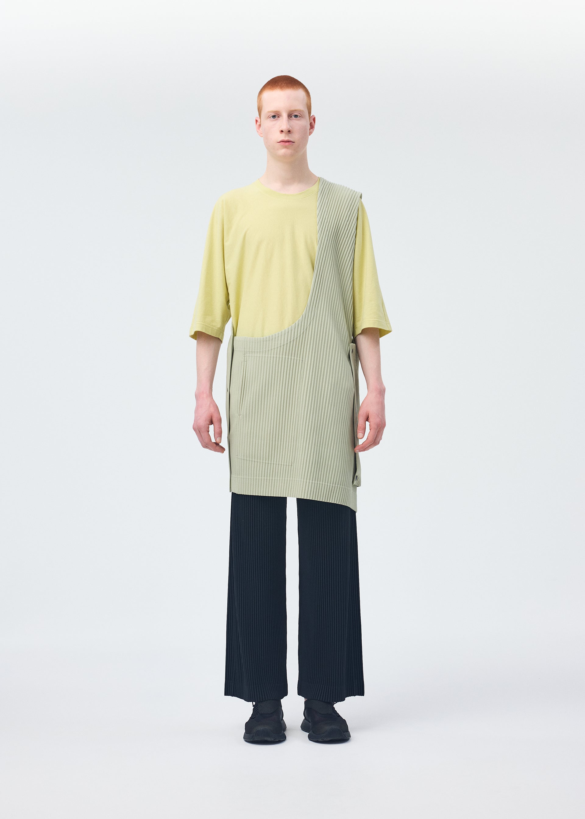 A model wears the HOMME PLISSÉ ISSEY MIYAKE STONE CLOUD vest.