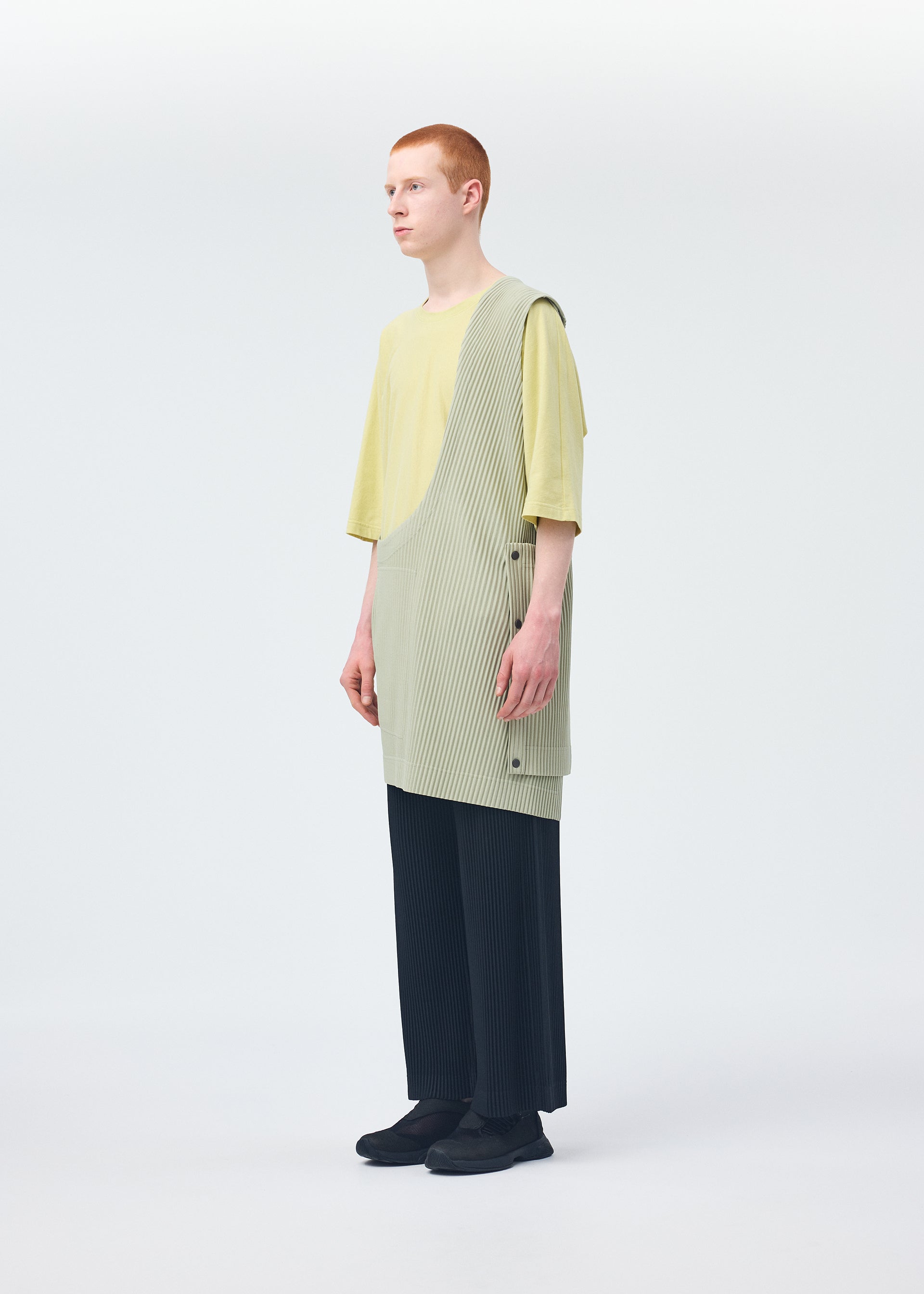 A model wears the HOMME PLISSÉ ISSEY MIYAKE STONE CLOUD vest.
