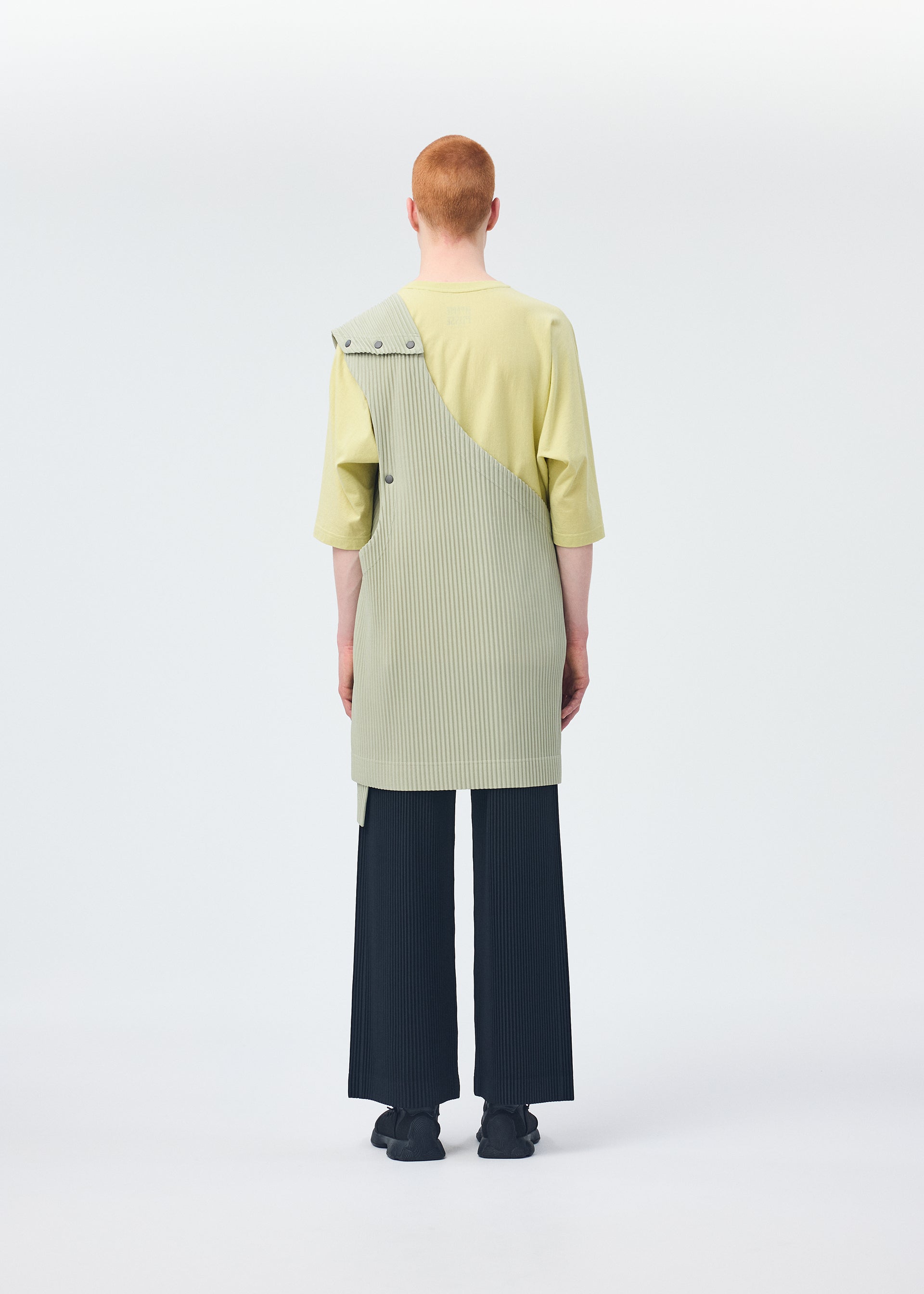 A model wears the HOMME PLISSÉ ISSEY MIYAKE STONE CLOUD vest.