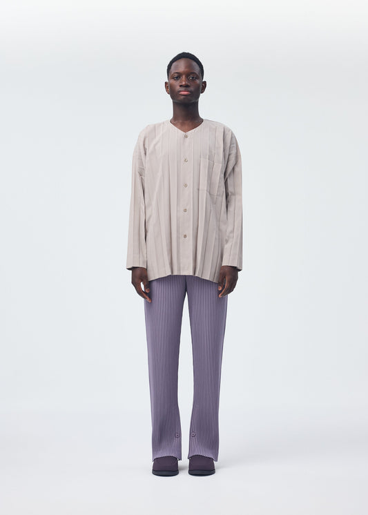 A model wears the HOMME PLISSÉ ISSEY MIYAKE PLEATS BOTTOMS 1 trousers.
