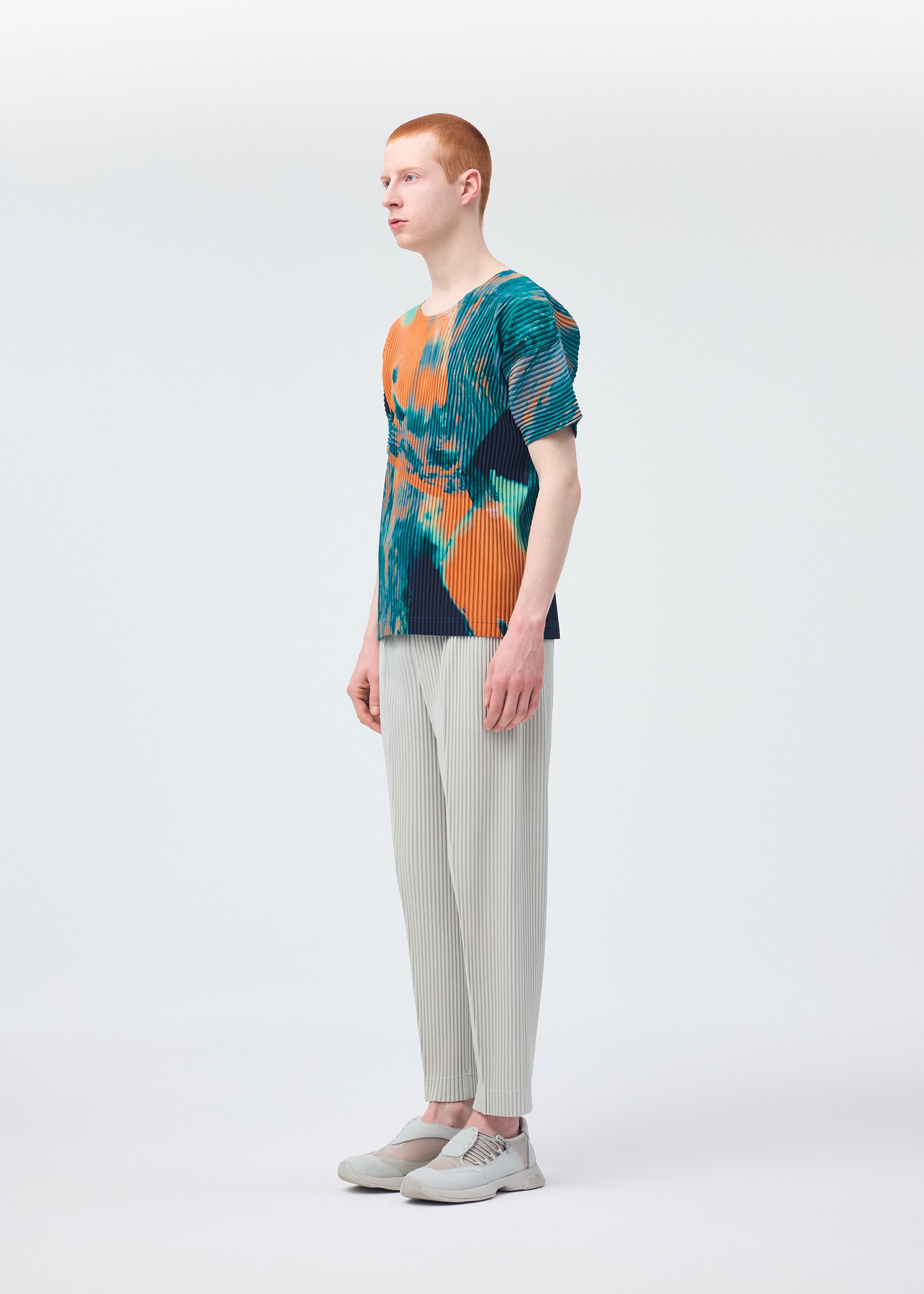 A model wears the HOMME PLISSÉ ISSEY MIYAKE AGATE top.
