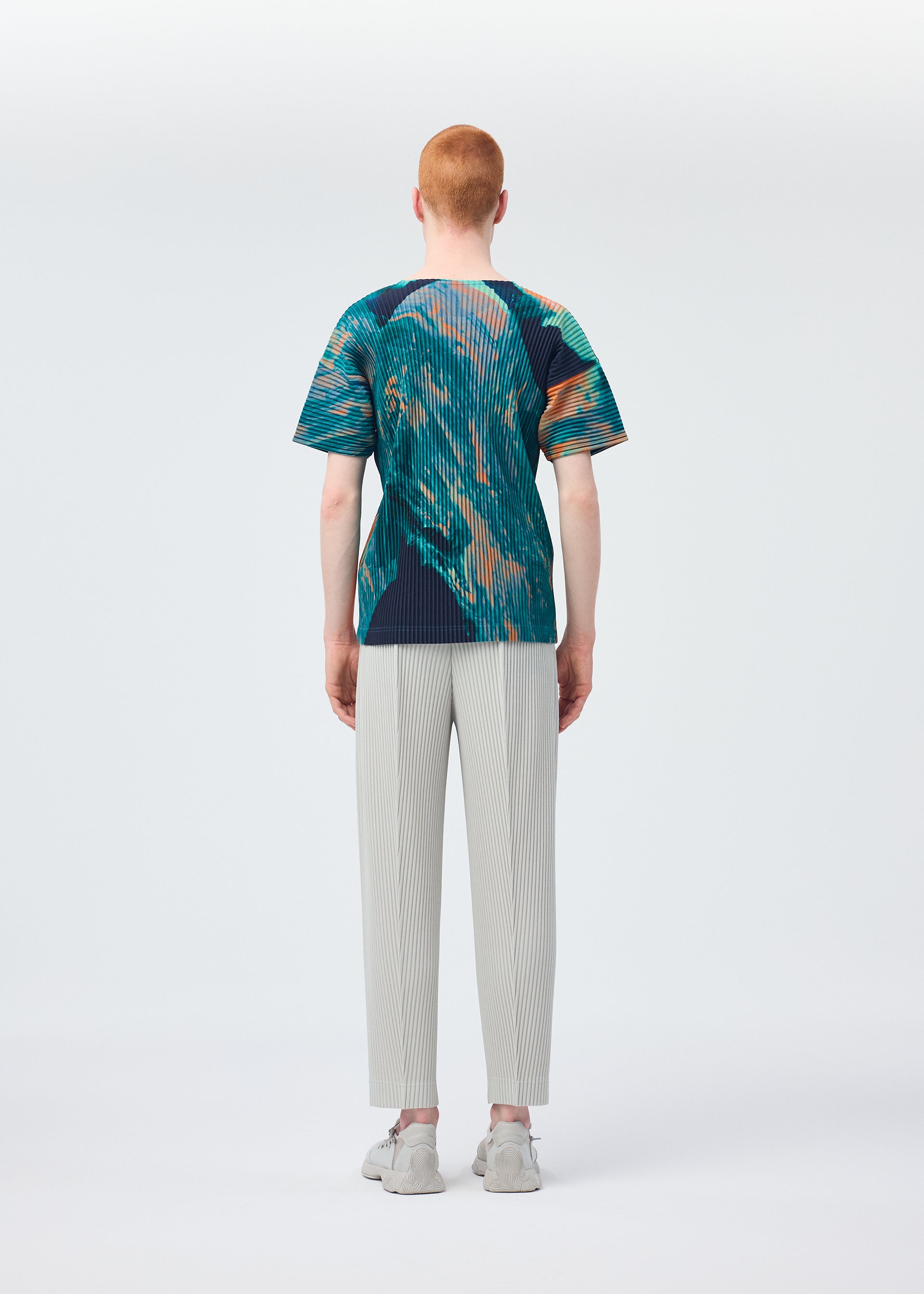 A model wears the HOMME PLISSÉ ISSEY MIYAKE AGATE top.