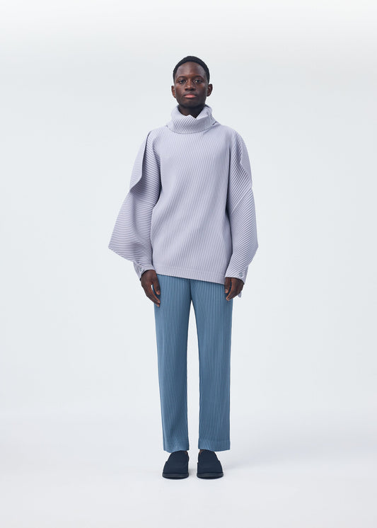 A model wears the HOMME PLISSÉ ISSEY MIYAKE ANGULAR STONE top.