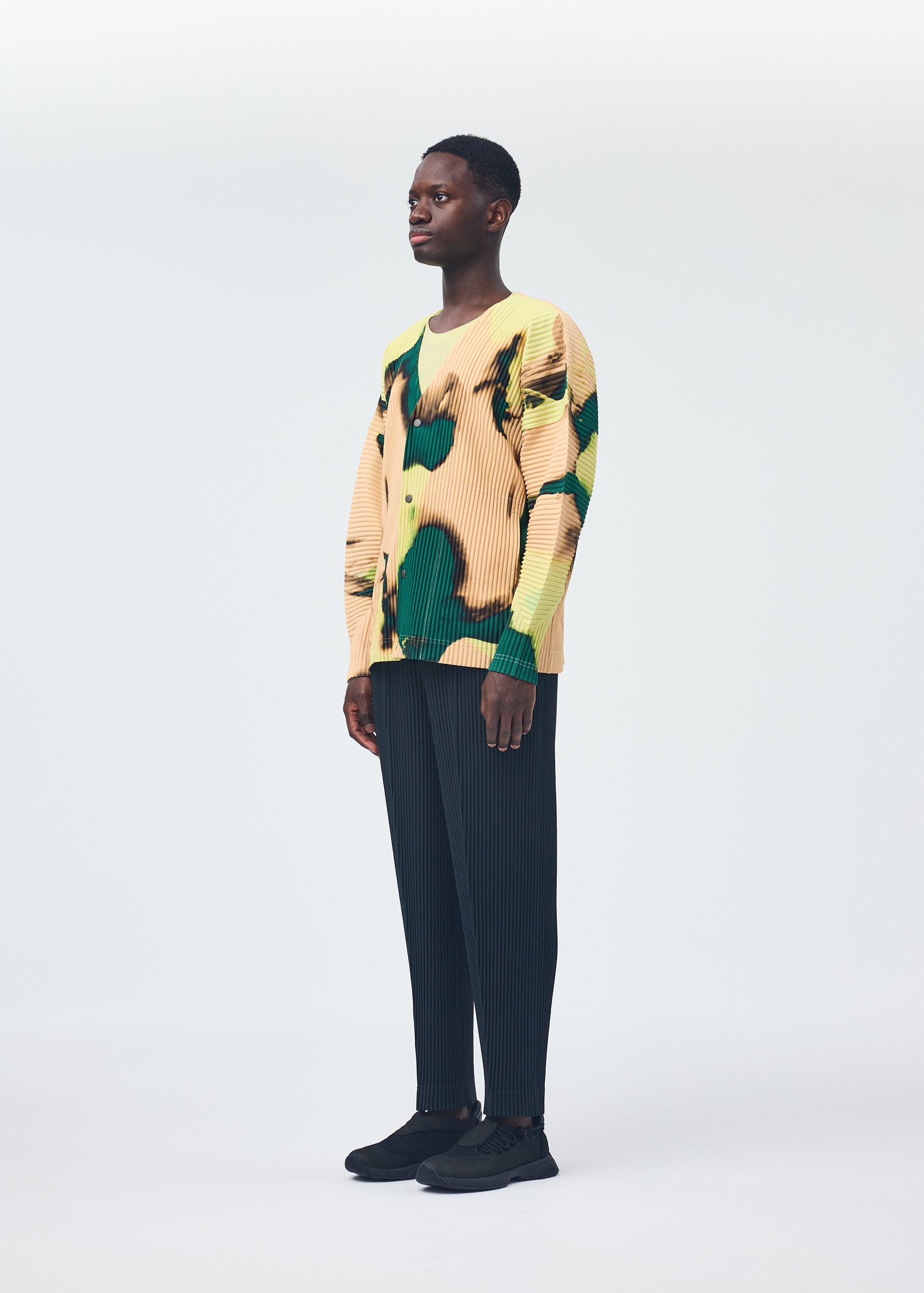 A model wears the HOMME PLISSÉ ISSEY MIYAKE AGATE shirt.