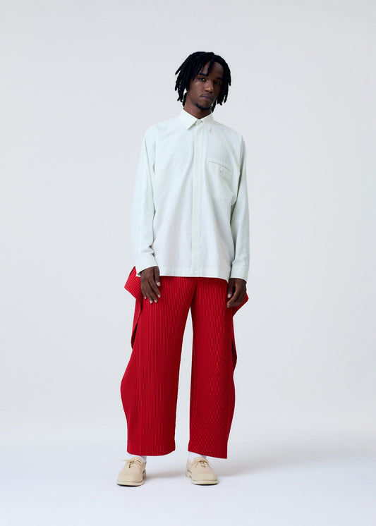 A model wears the HOMME PLISSÉ ISSEY MIYAKE STREAMLINE SHIRT clothing.