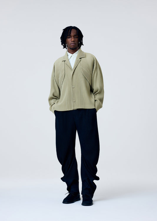 A model wears the HOMME PLISSÉ ISSEY MIYAKE COVER AND FOLD clothing.