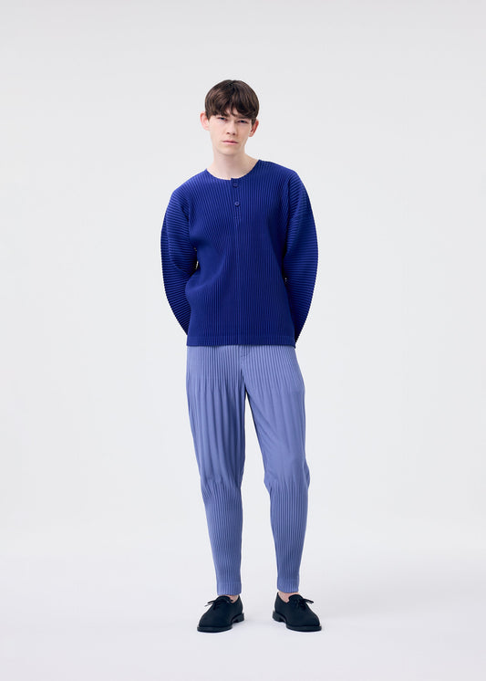 A model wears the HOMME PLISSÉ ISSEY MIYAKE MONTHLY COLORS FEBRUARY trousers.