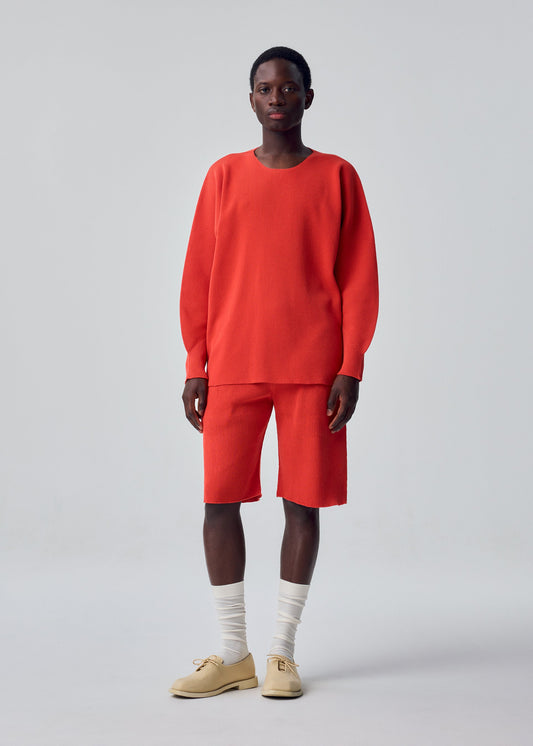A model wears the HOMME PLISSÉ ISSEY MIYAKE BASIC KNIT basic-knit-long-sleeved-jersey-top-light-grey.