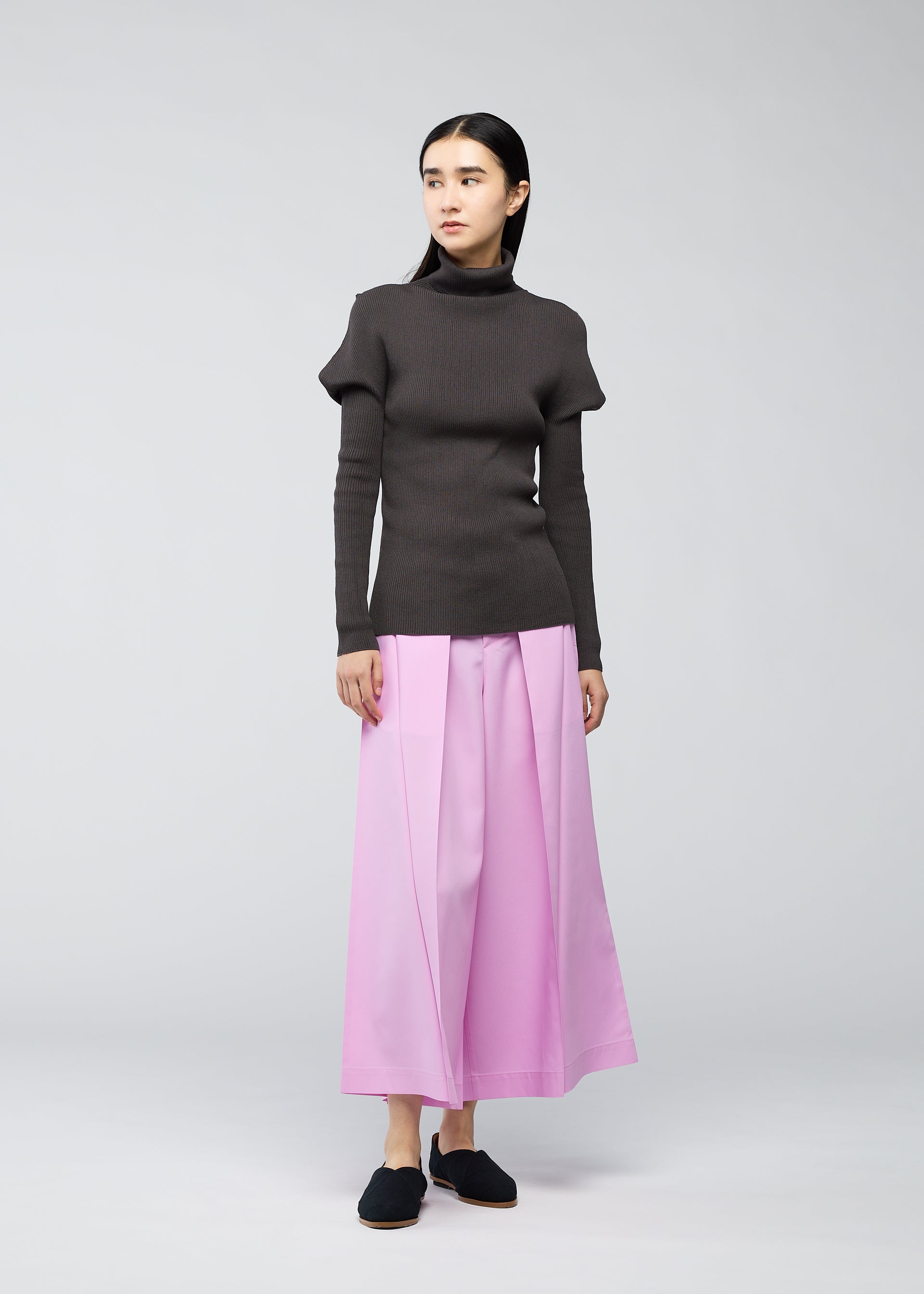 A model wears the 132 5. ISSEY MIYAKE FLAT RIB KNIT top