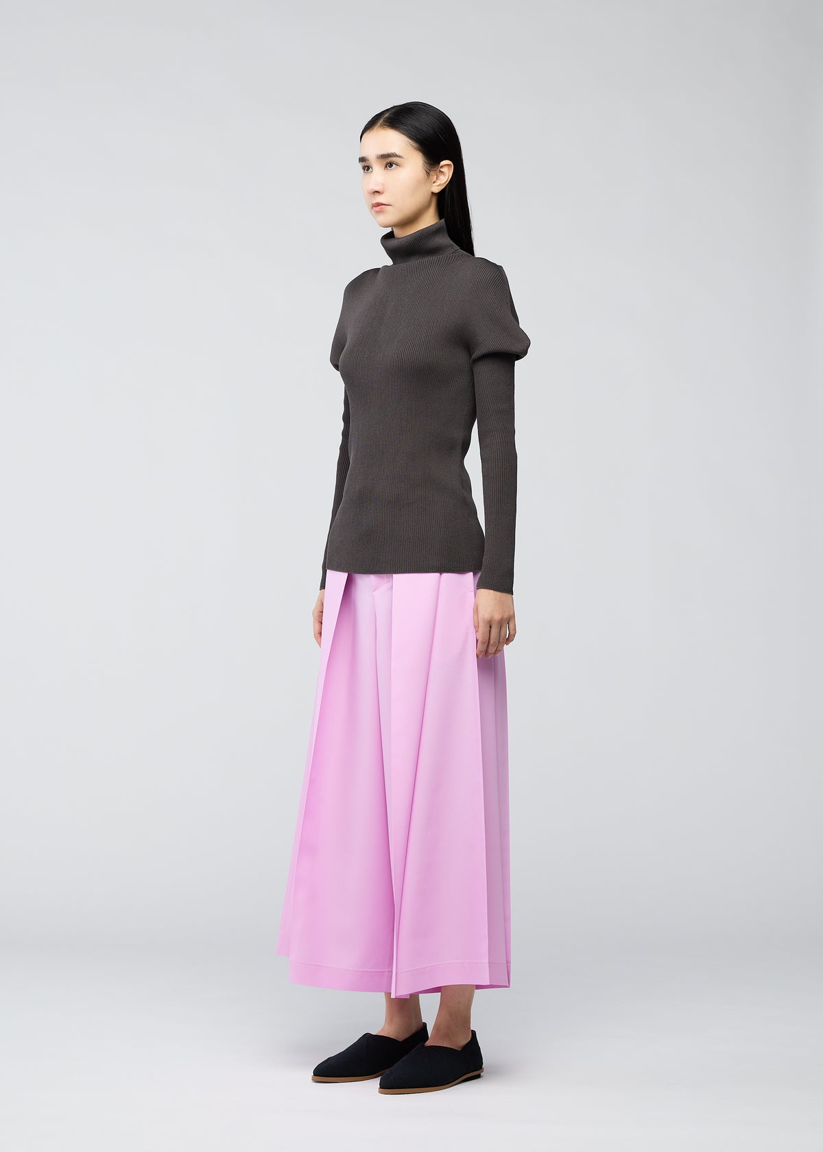 A model wears the 132 5. ISSEY MIYAKE FLAT RIB KNIT top