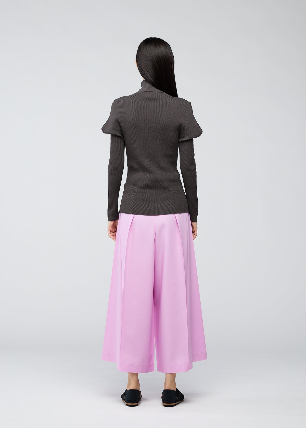 A model wears the 132 5. ISSEY MIYAKE FLAT RIB KNIT top