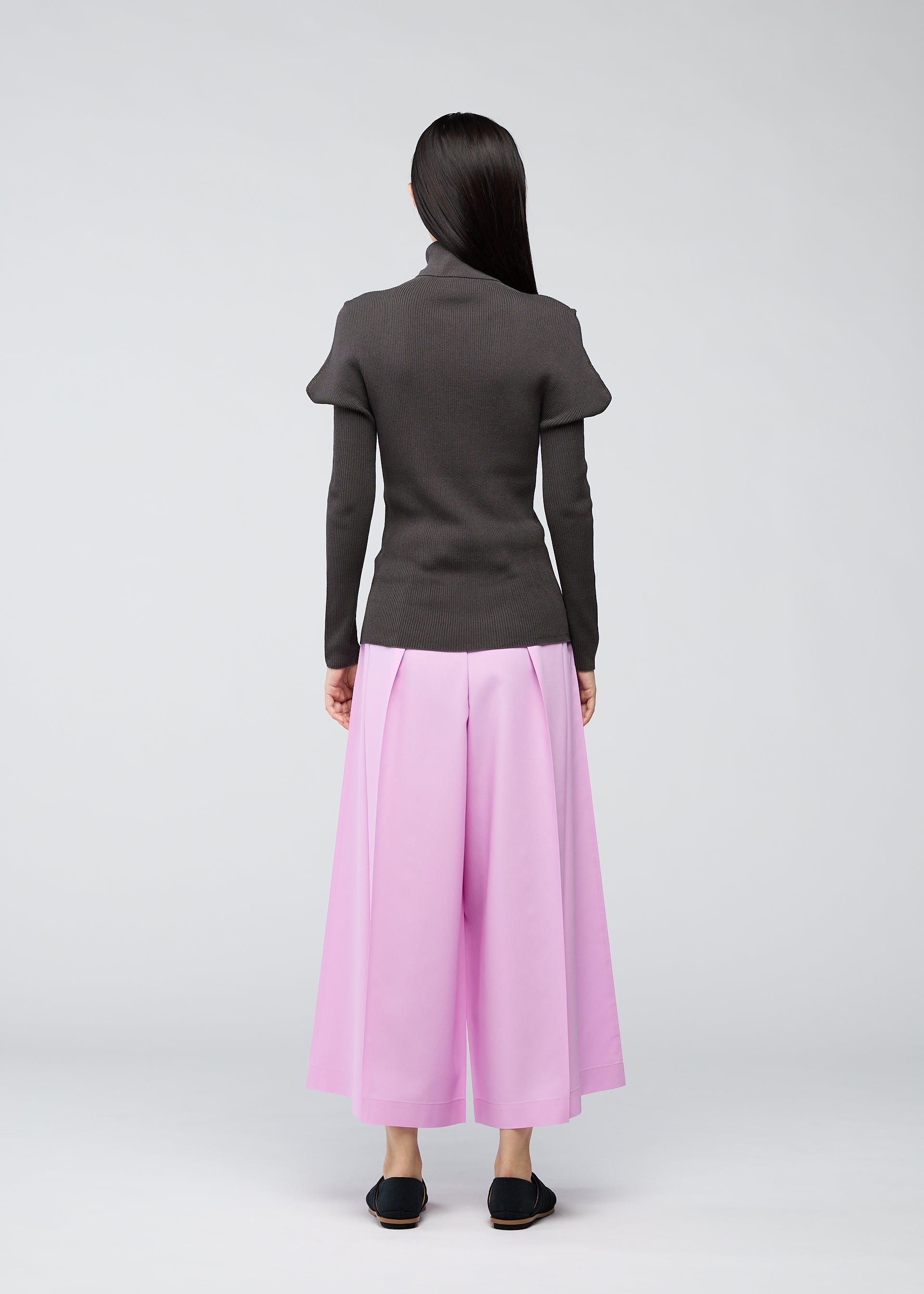 A model wears the 132 5. ISSEY MIYAKE FLAT RIB KNIT top