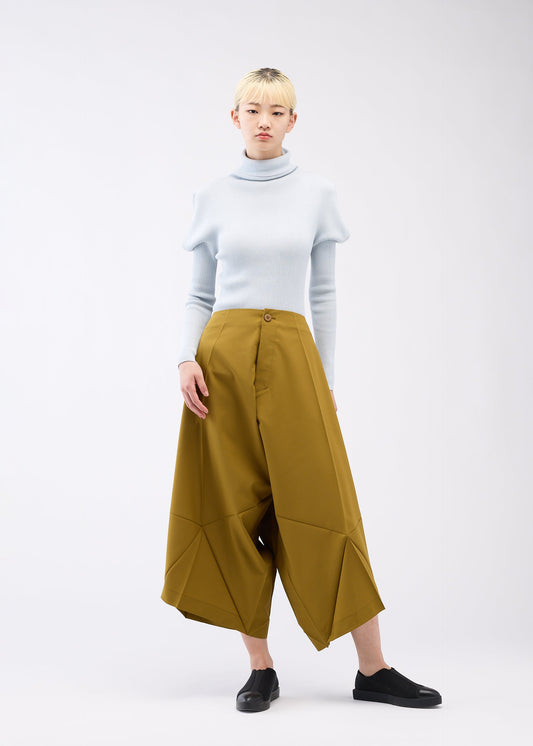 A model wears the 132 5. ISSEY MIYAKE UNIFIED HALF CUBES trousers.