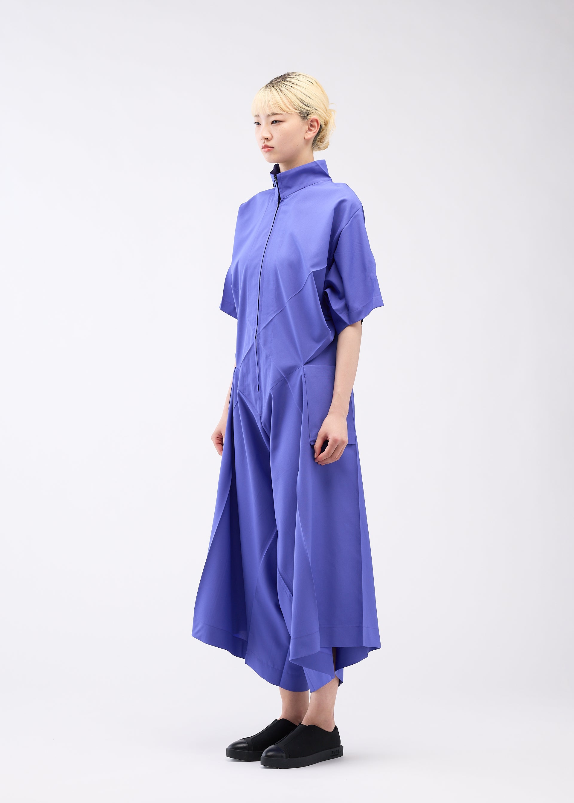 A model wears the 132 5. ISSEY MIYAKE UNIFIED HALF CUBES jumpsuit.