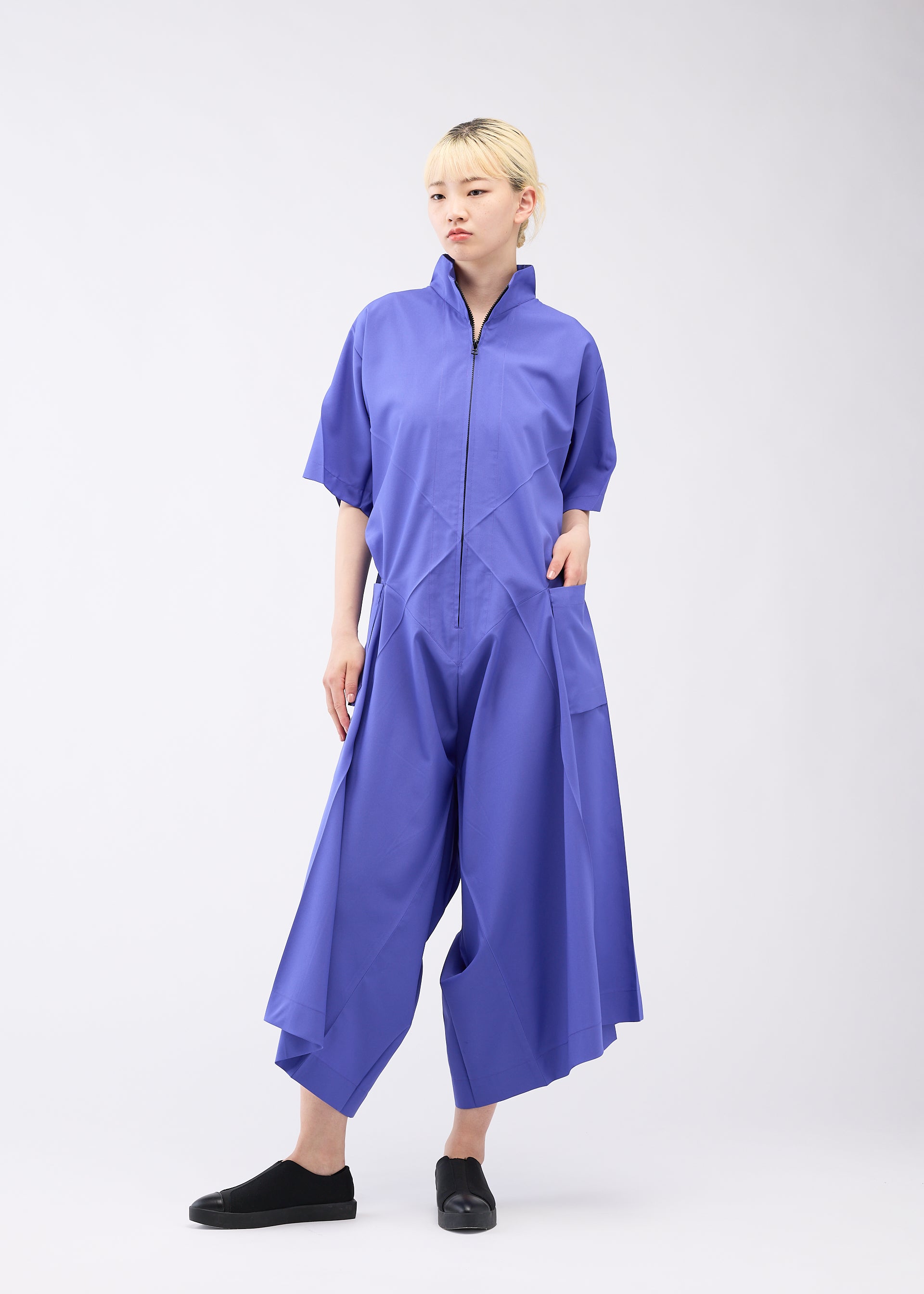 A model wears the 132 5. ISSEY MIYAKE UNIFIED HALF CUBES jumpsuit.