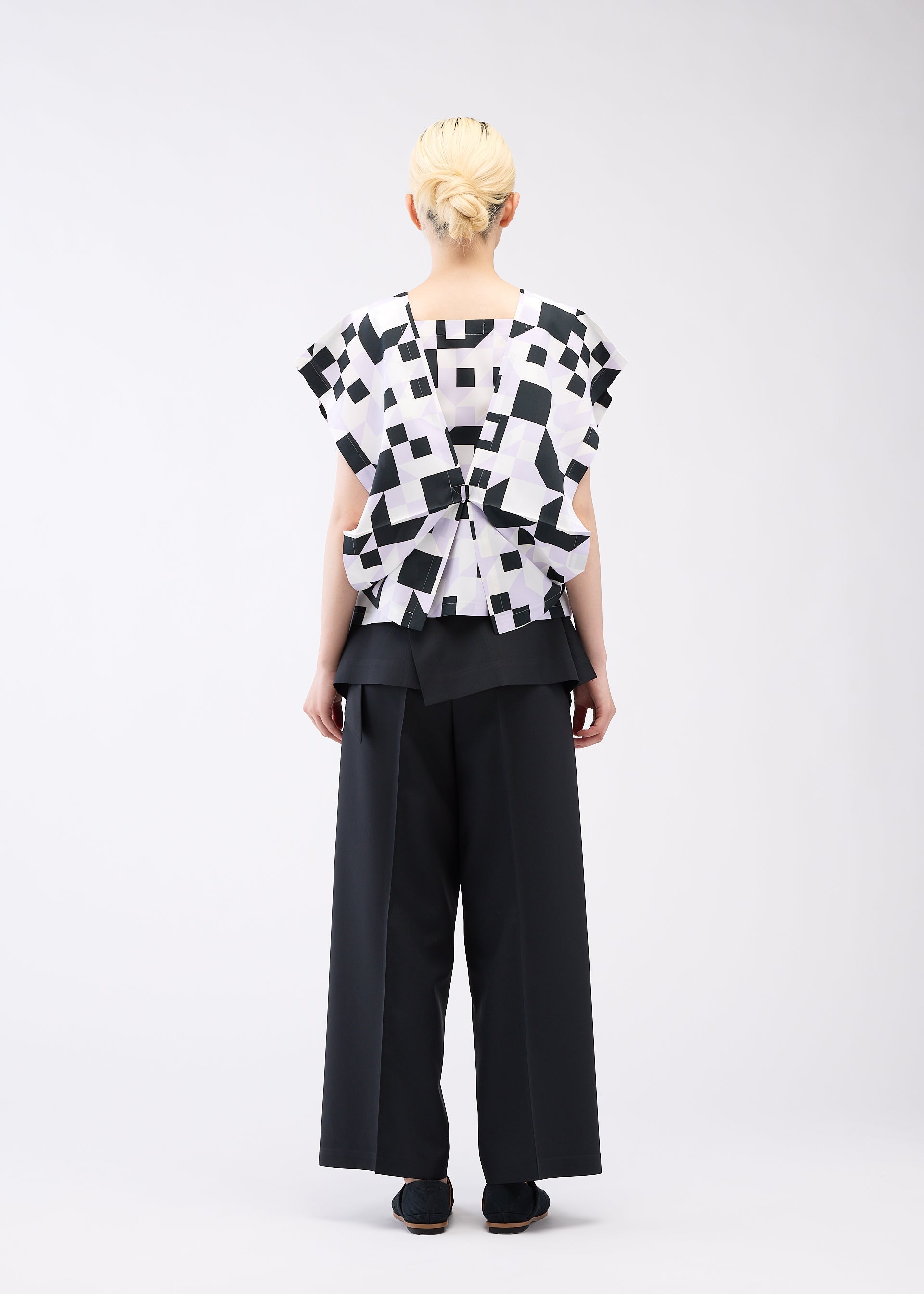 A model wears the 132 5. ISSEY MIYAKE BOX COMPOSITION shirt.