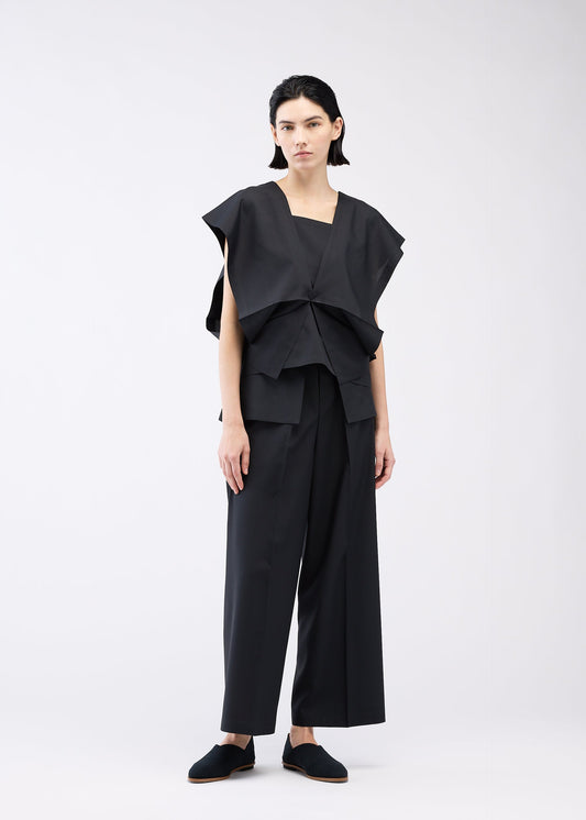 A model wears the 132 5. ISSEY MIYAKE BOX COMPOSITION SOLID shirt.