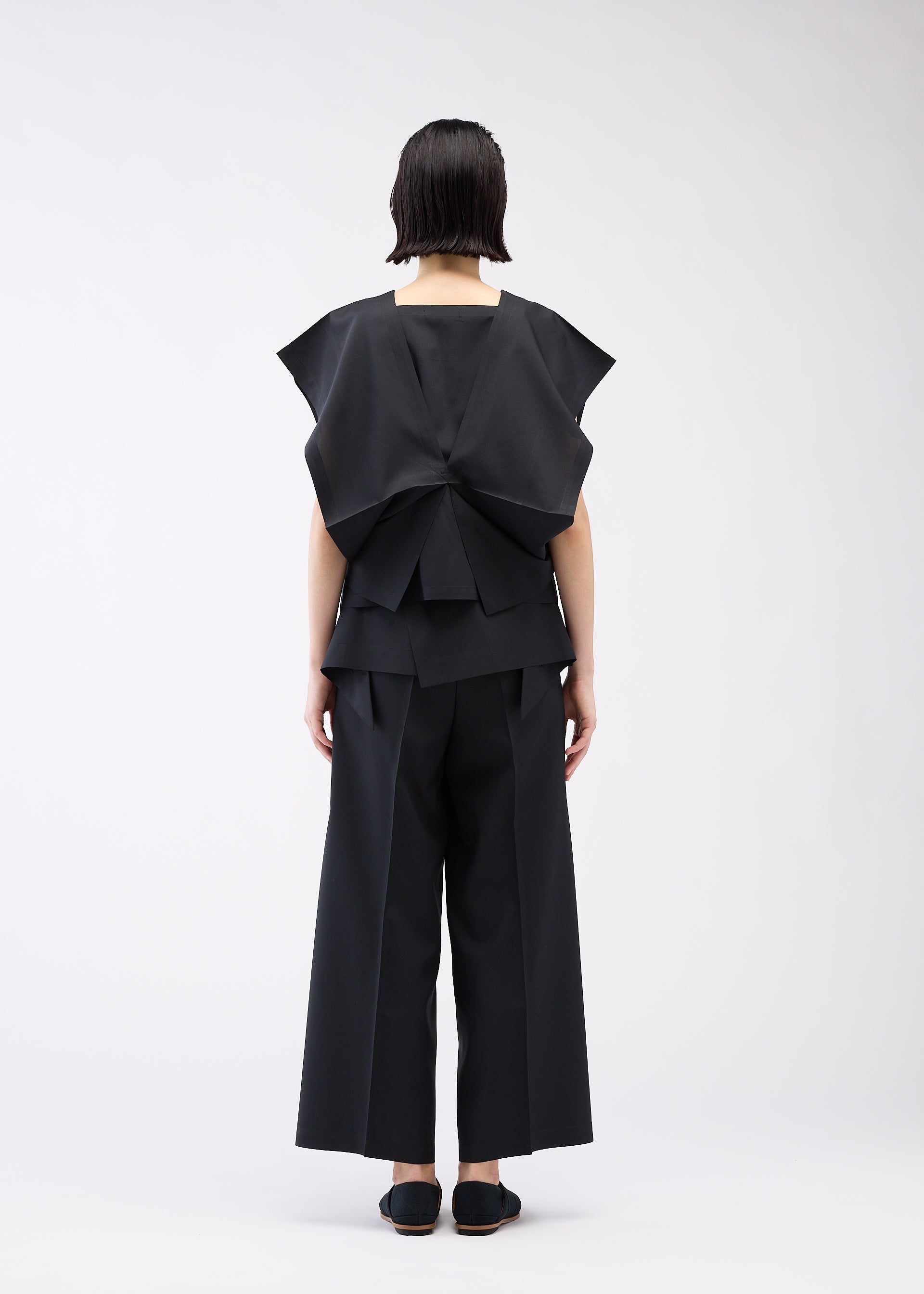 A model wears the 132 5. ISSEY MIYAKE BOX COMPOSITION SOLID shirt.
