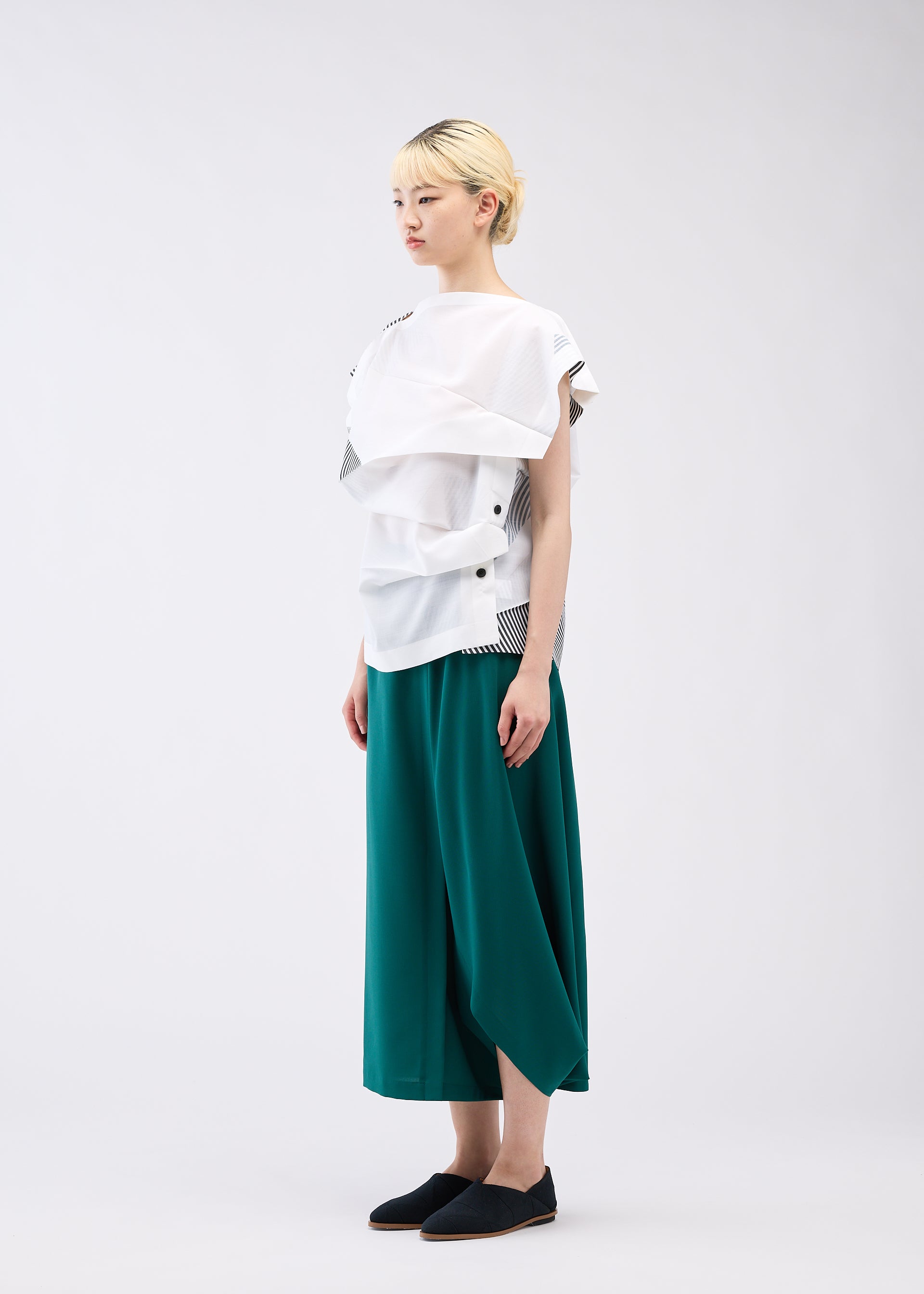 A model wears the 132 5. ISSEY MIYAKE FOLD RAMIE PRINT shirt.