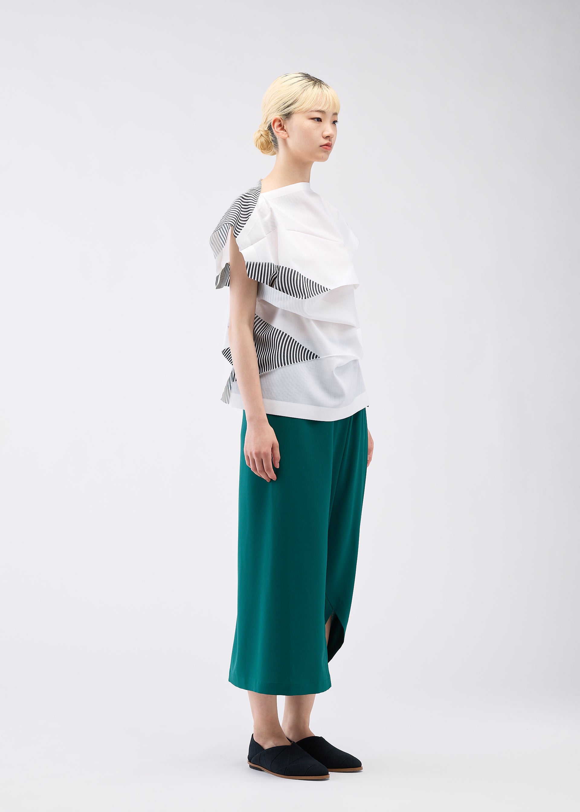 A model wears the 132 5. ISSEY MIYAKE FOLD RAMIE PRINT shirt.