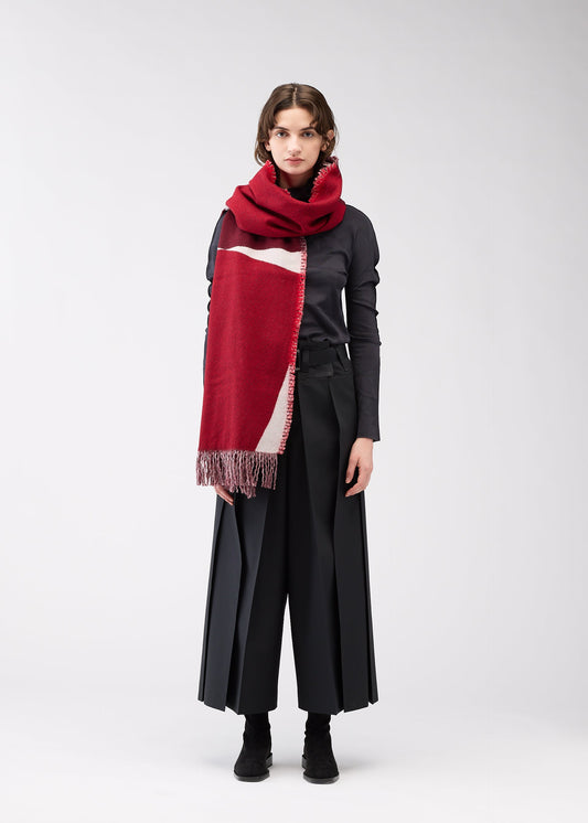 A model wears the 132 5. ISSEY MIYAKE POSITIONS STOLE stole.