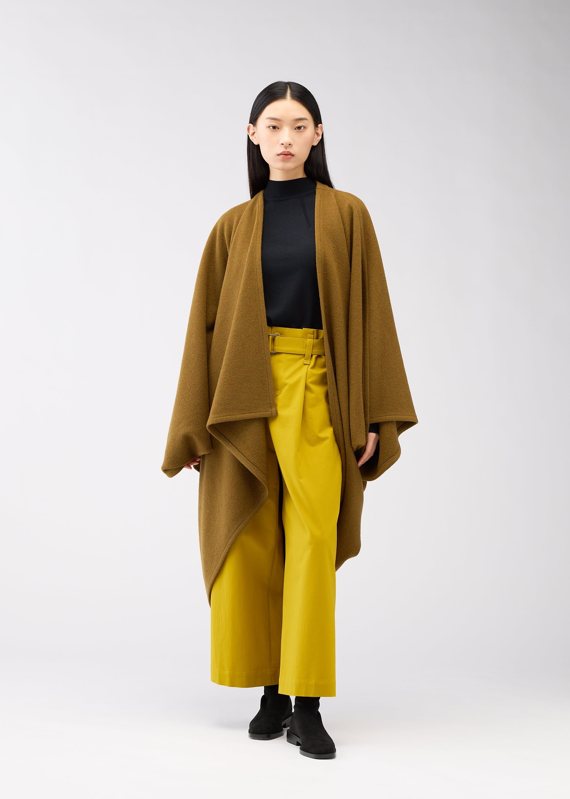 A model wears the 132 5. ISSEY MIYAKE DRAPE COAT coat.