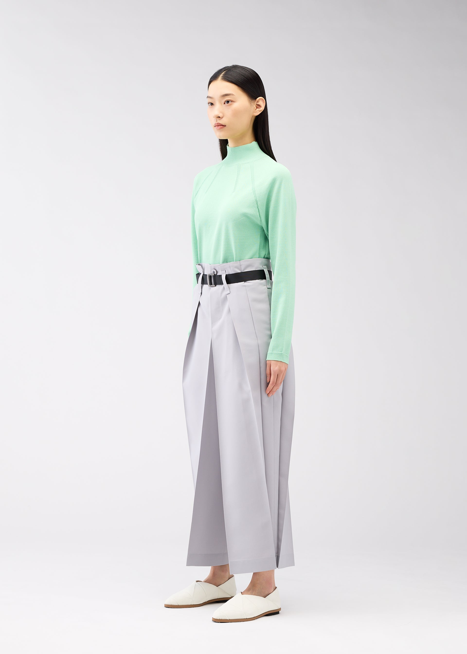 A model wears the 132 5. ISSEY MIYAKE FLAT SQUARE BOTTOMS trousers.