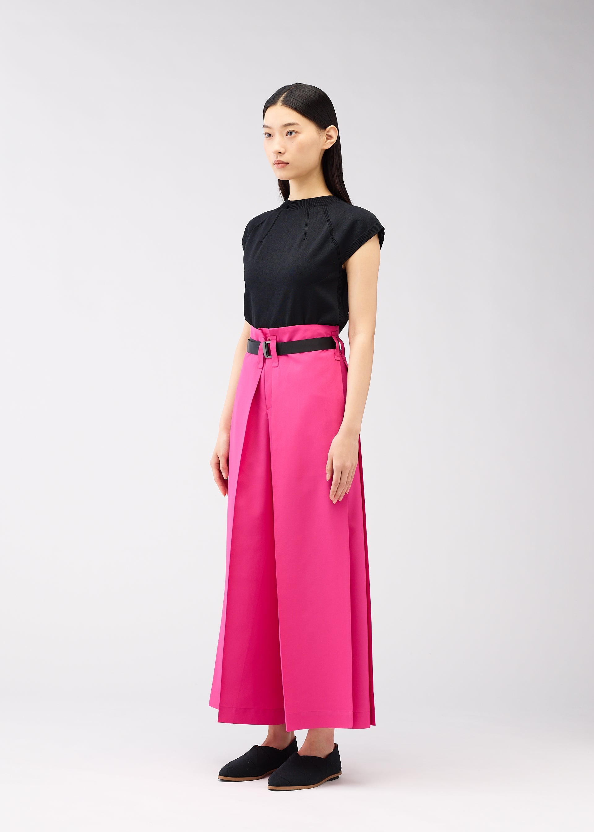 A model wears the 132 5. ISSEY MIYAKE FLAT SQUARE BOTTOMS trousers.