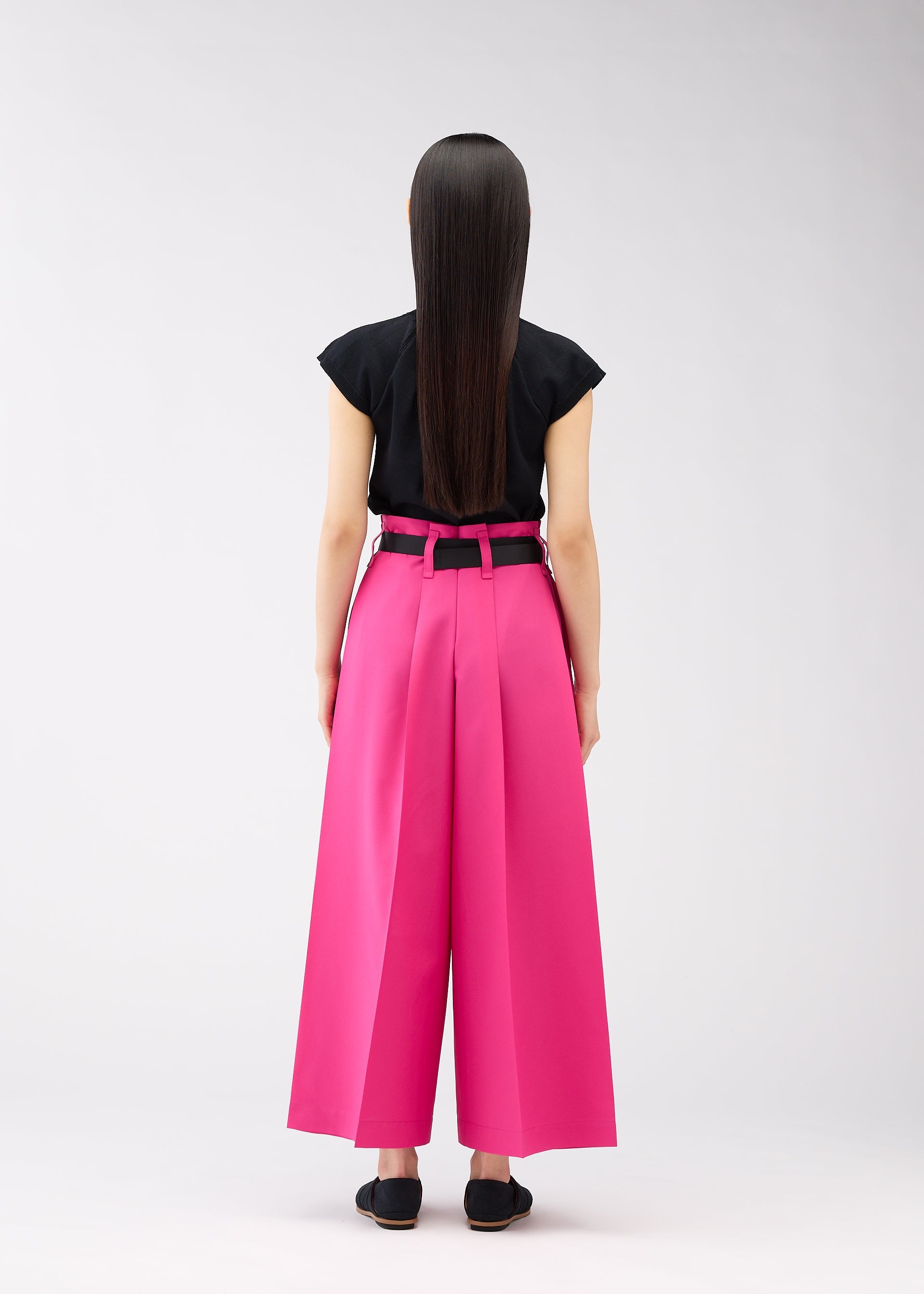 A model wears the 132 5. ISSEY MIYAKE FLAT SQUARE BOTTOMS trousers.