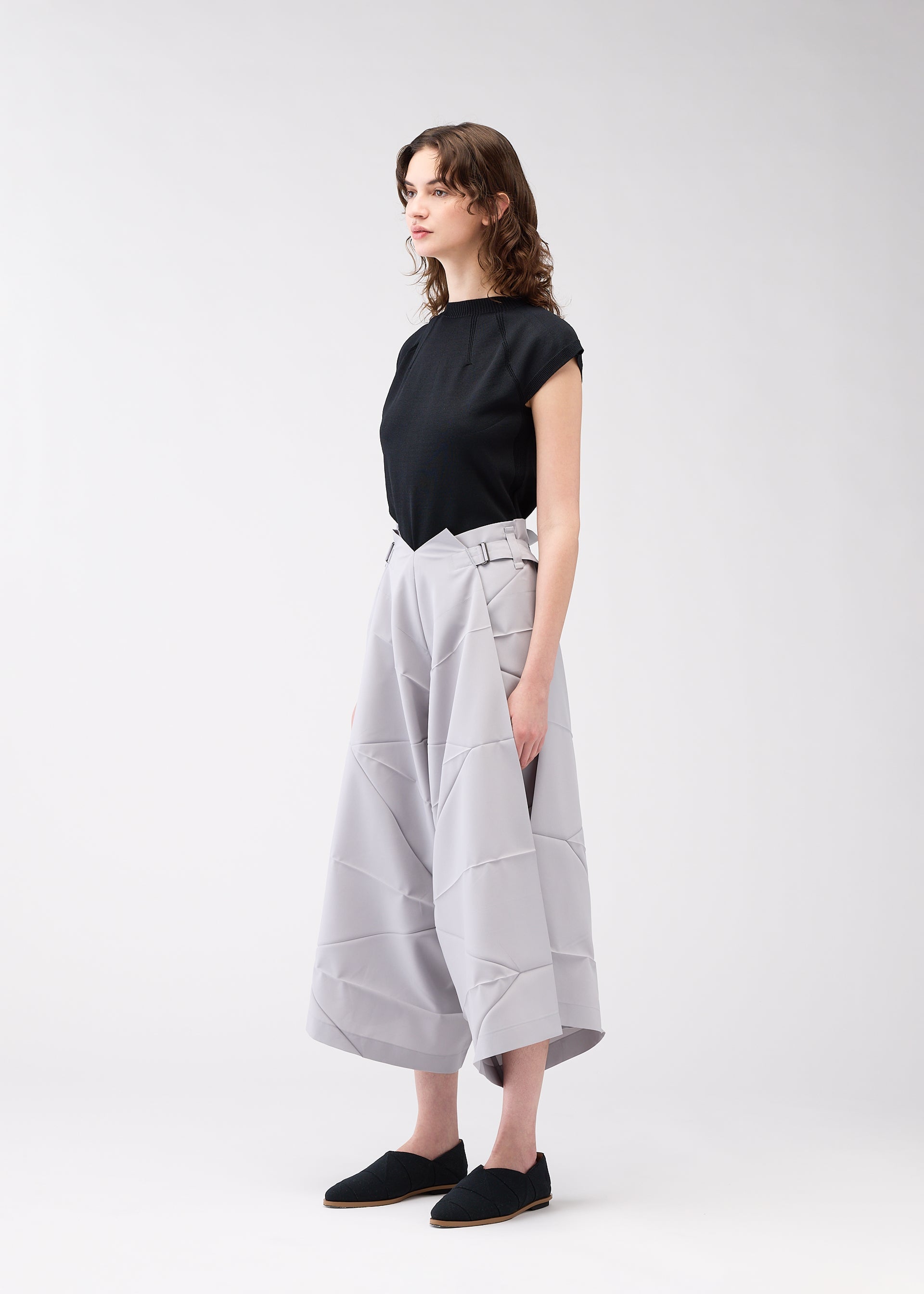 A model wears the 132 5. ISSEY MIYAKE NO.2 trousers.