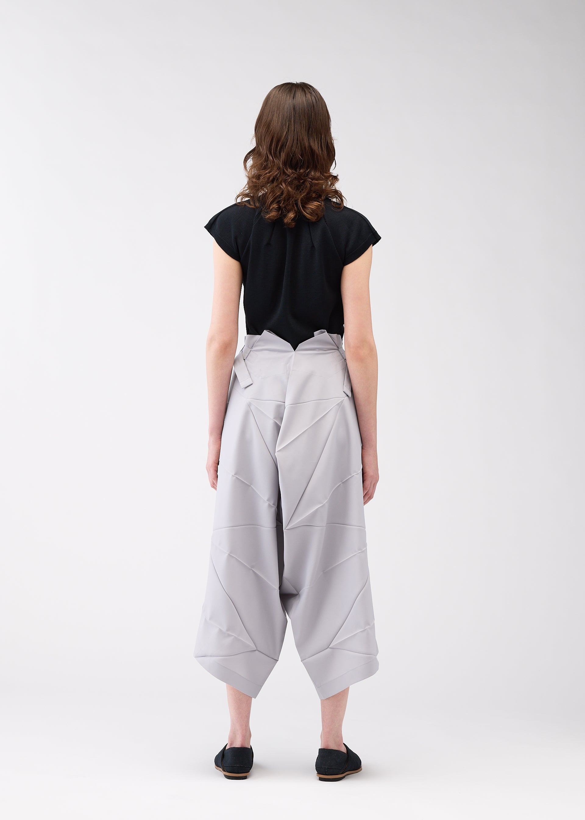 A model wears the 132 5. ISSEY MIYAKE NO.2 trousers.