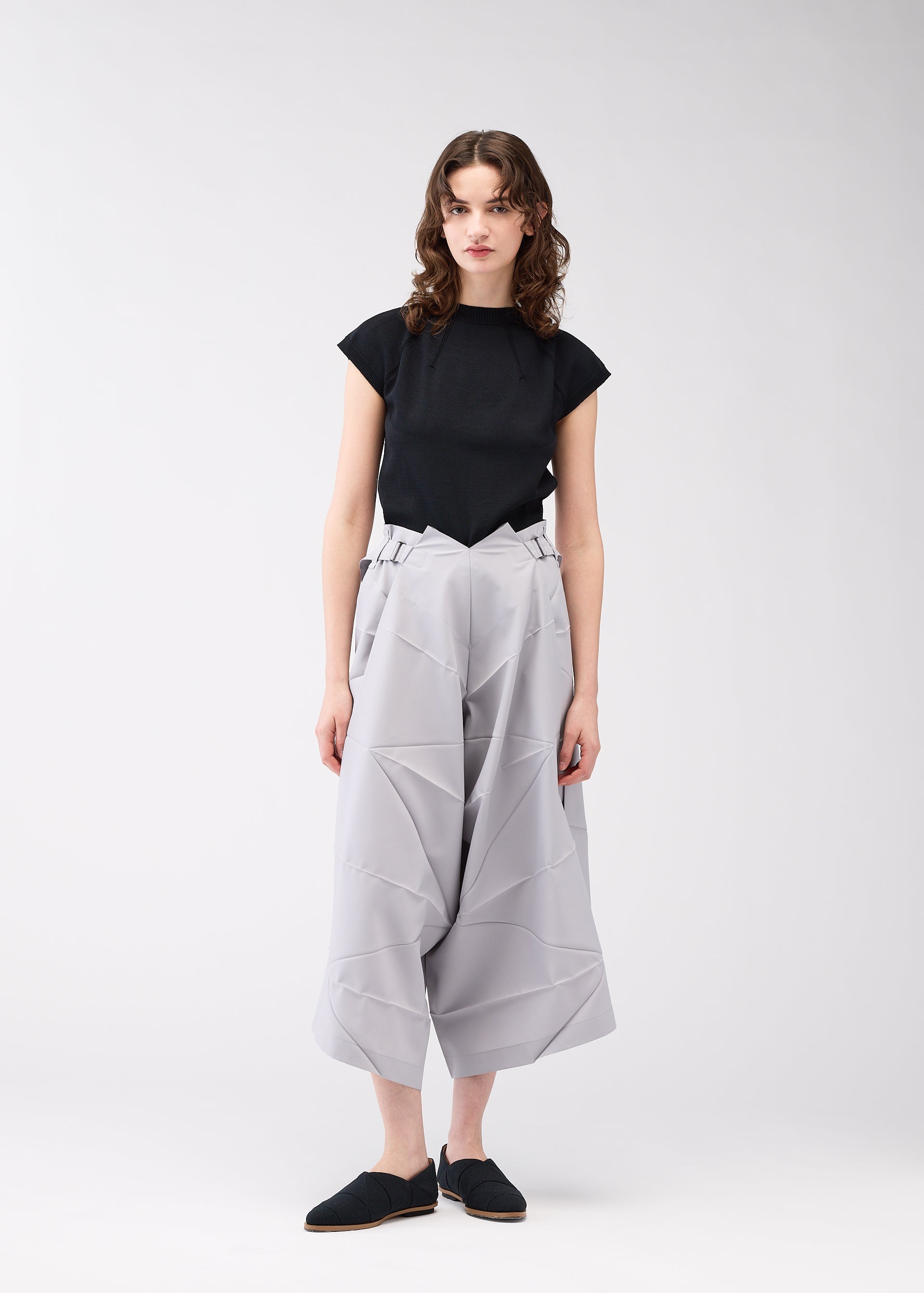 A model wears the 132 5. ISSEY MIYAKE NO.2 trousers.