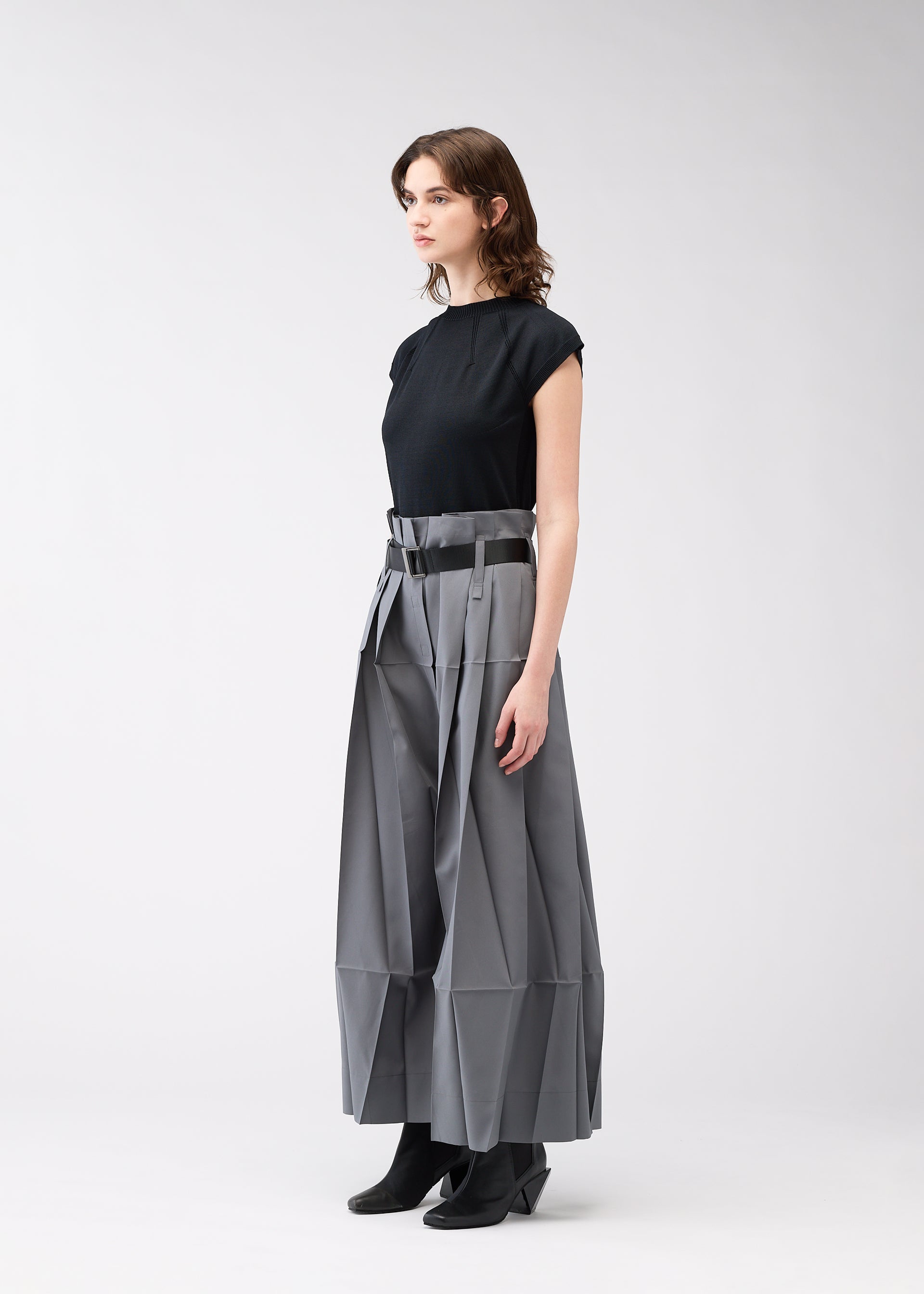 A model wears the 132 5. ISSEY MIYAKE NO.3 trousers.