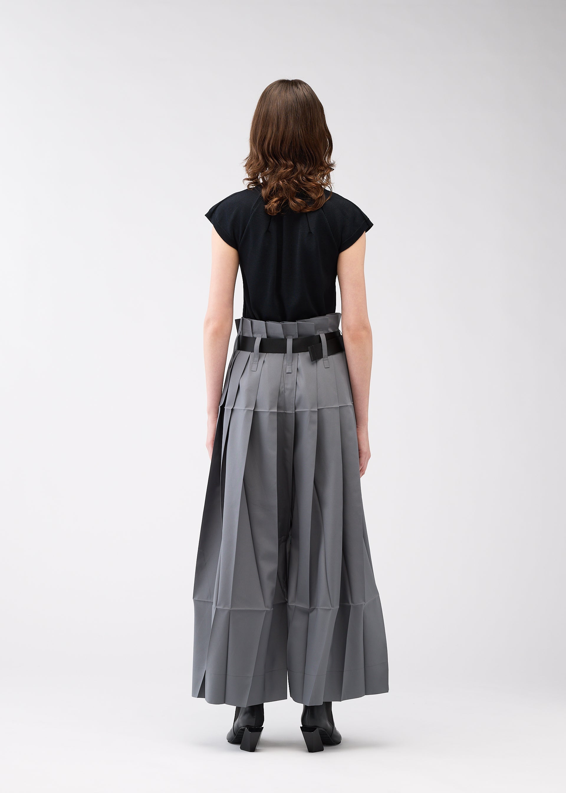 A model wears the 132 5. ISSEY MIYAKE NO.3 trousers.