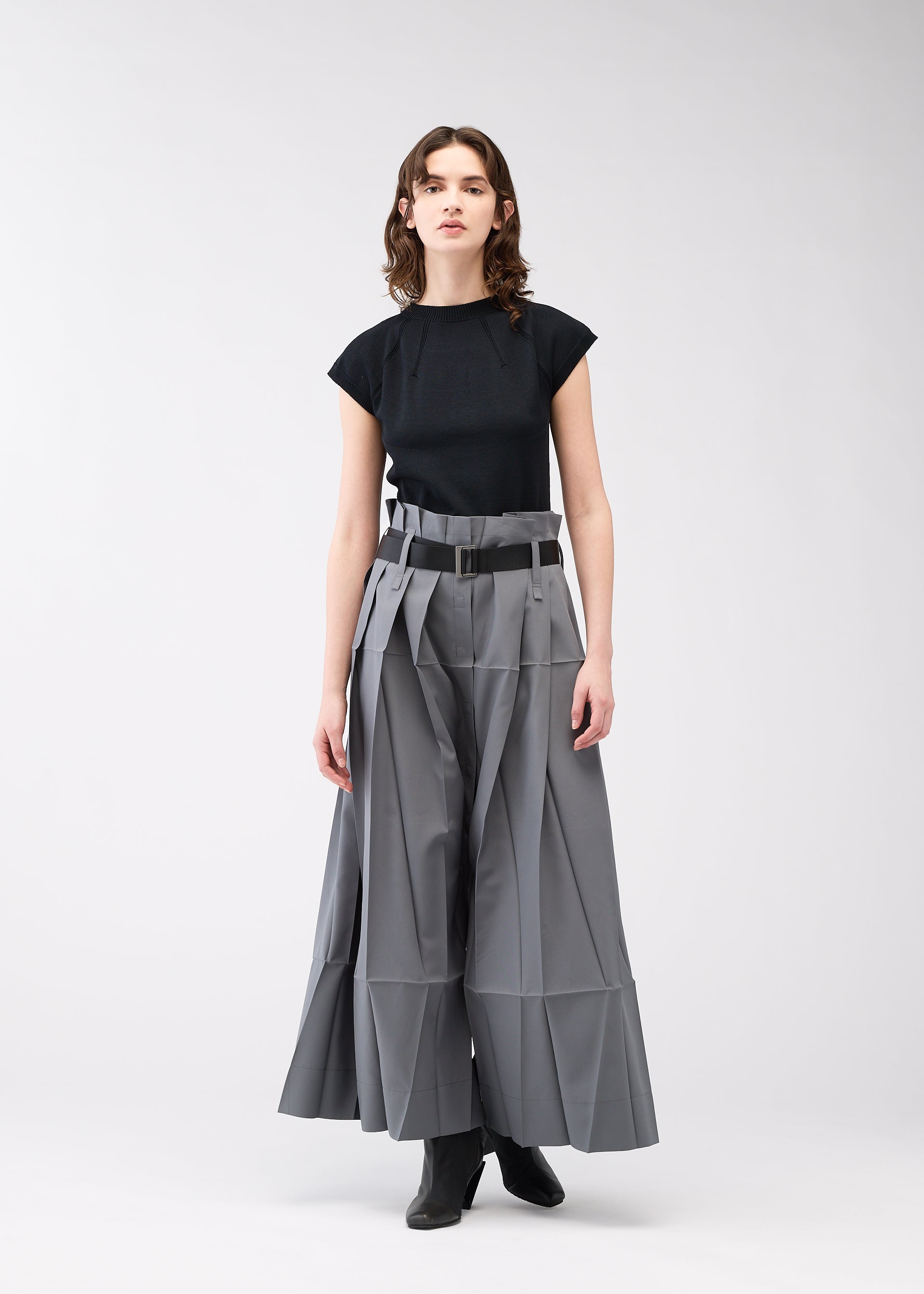 A model wears the 132 5. ISSEY MIYAKE NO.3 trousers.
