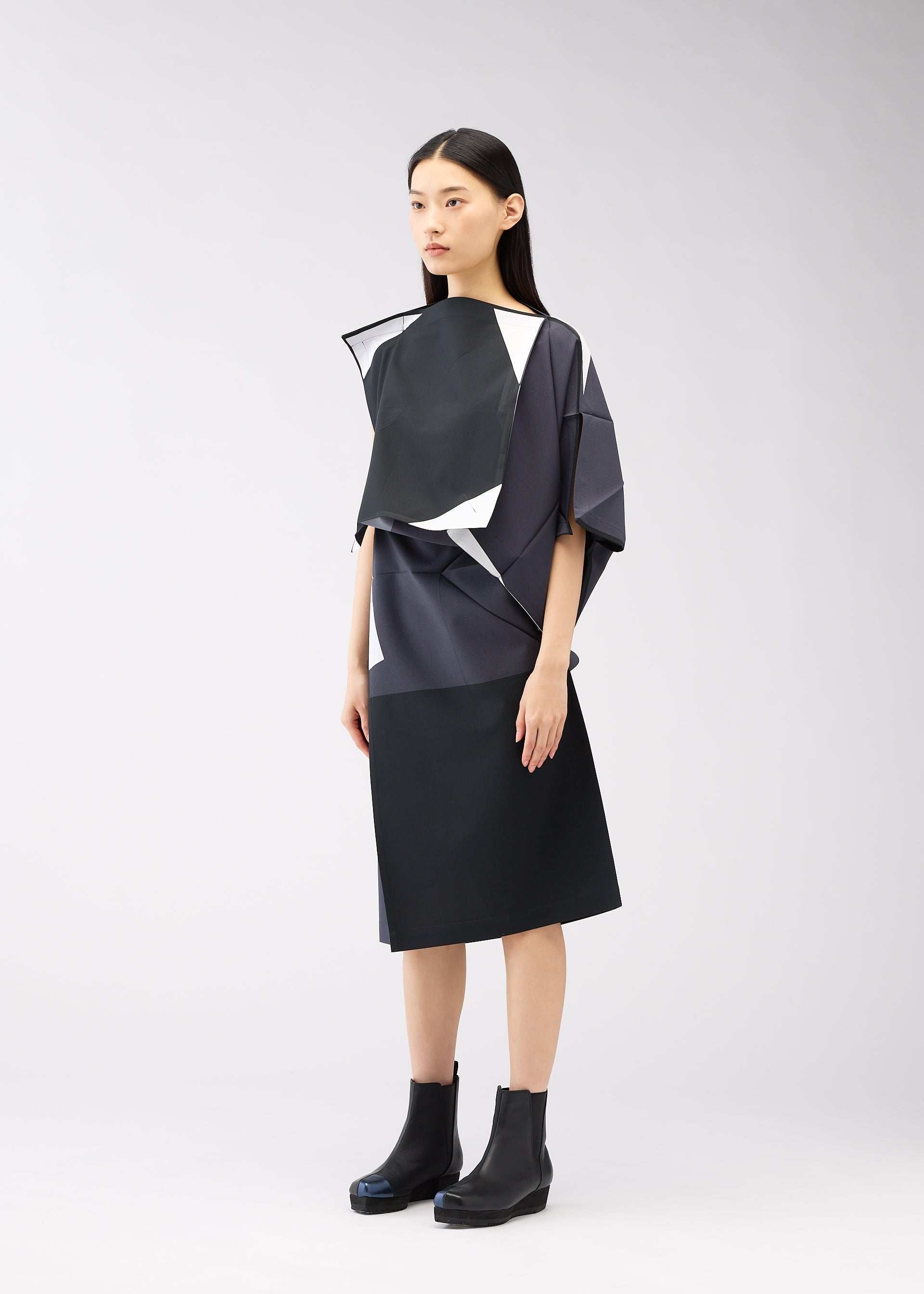 A model wears the 132 5. ISSEY MIYAKE POSITIONS dress.