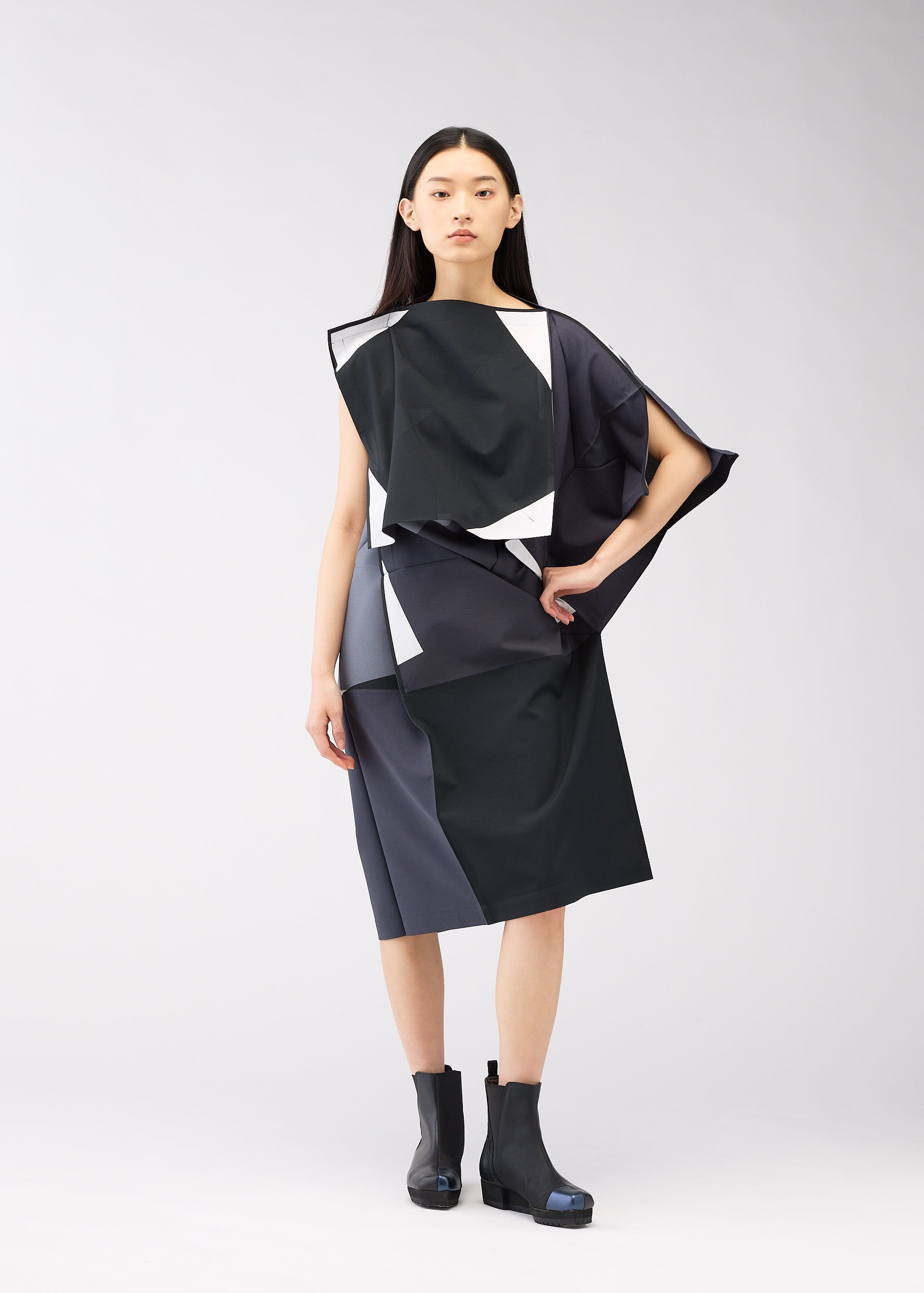 A model wears the 132 5. ISSEY MIYAKE POSITIONS dress.