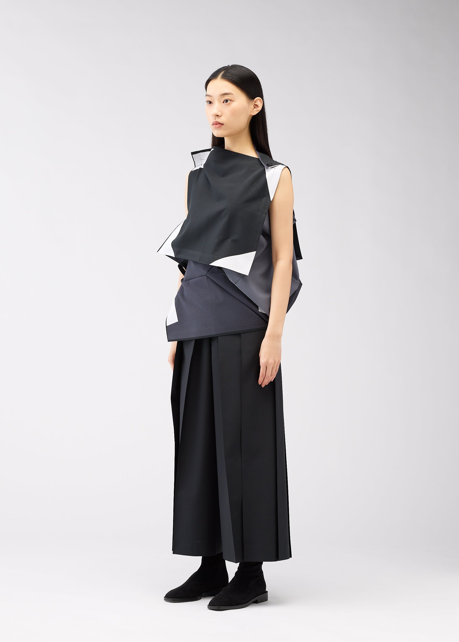 A model wears the 132 5. ISSEY MIYAKE POSITIONS shirt.