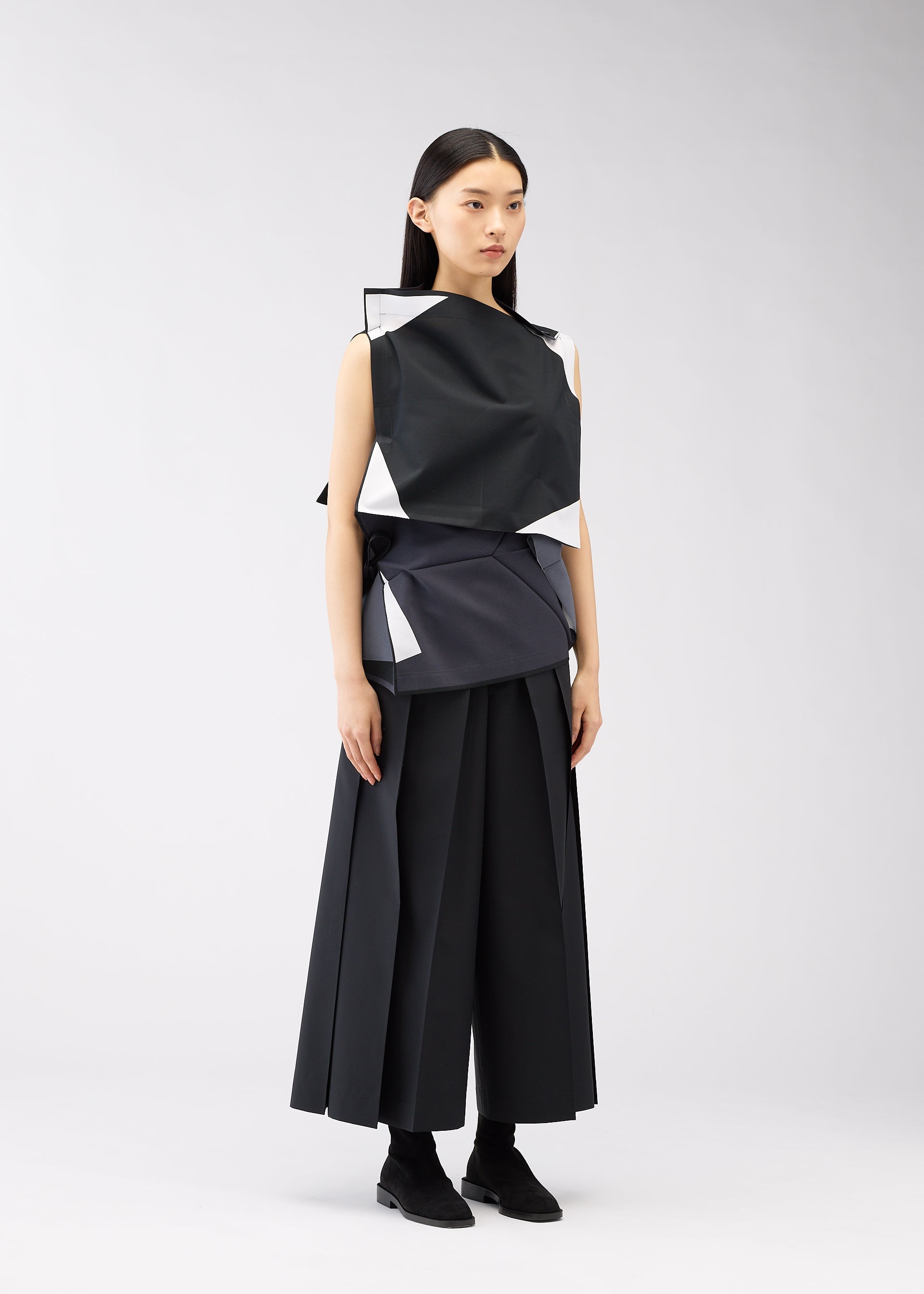 A model wears the 132 5. ISSEY MIYAKE POSITIONS shirt.