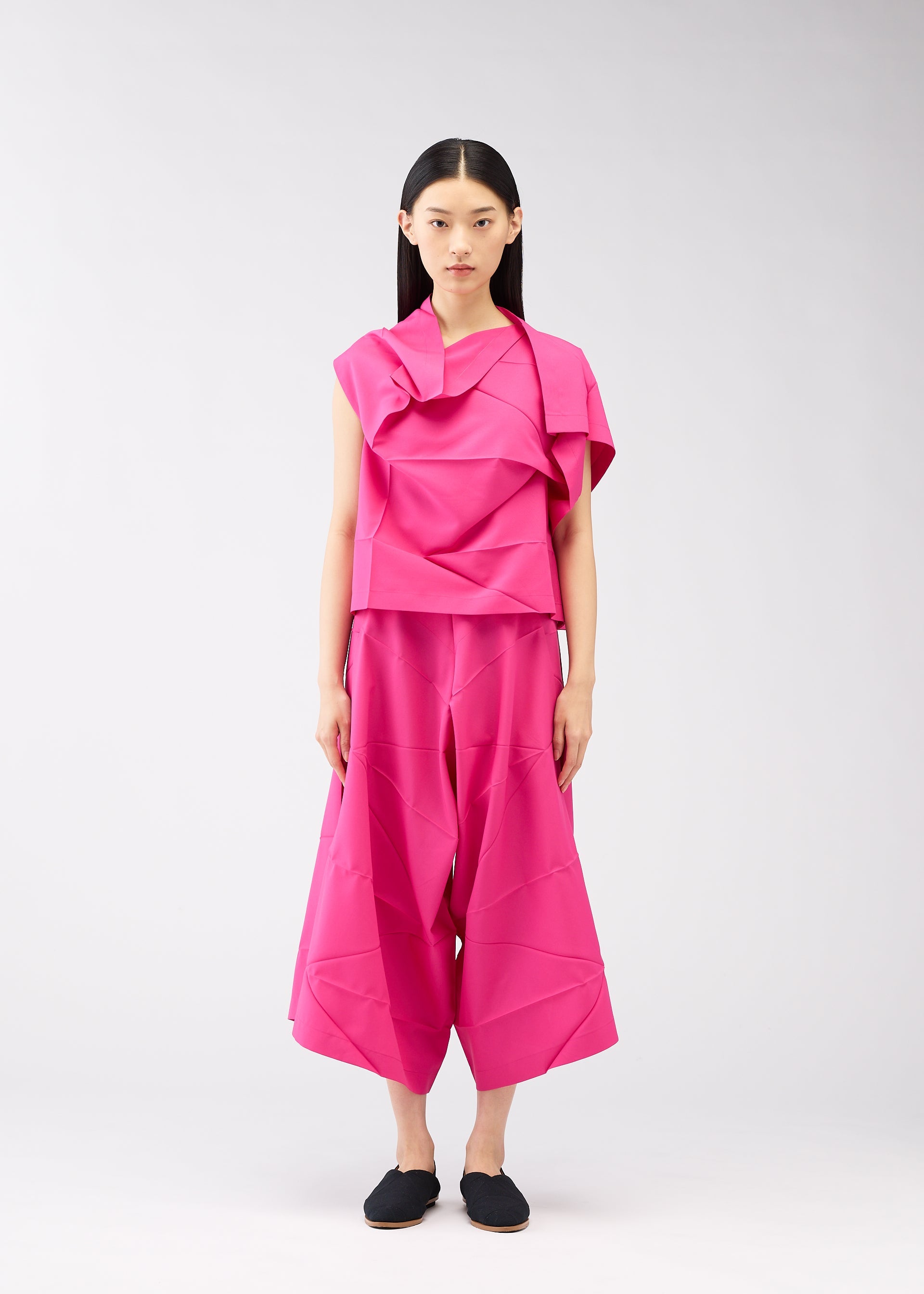 A model wears the 132 5. ISSEY MIYAKE NO.2 shirt.
