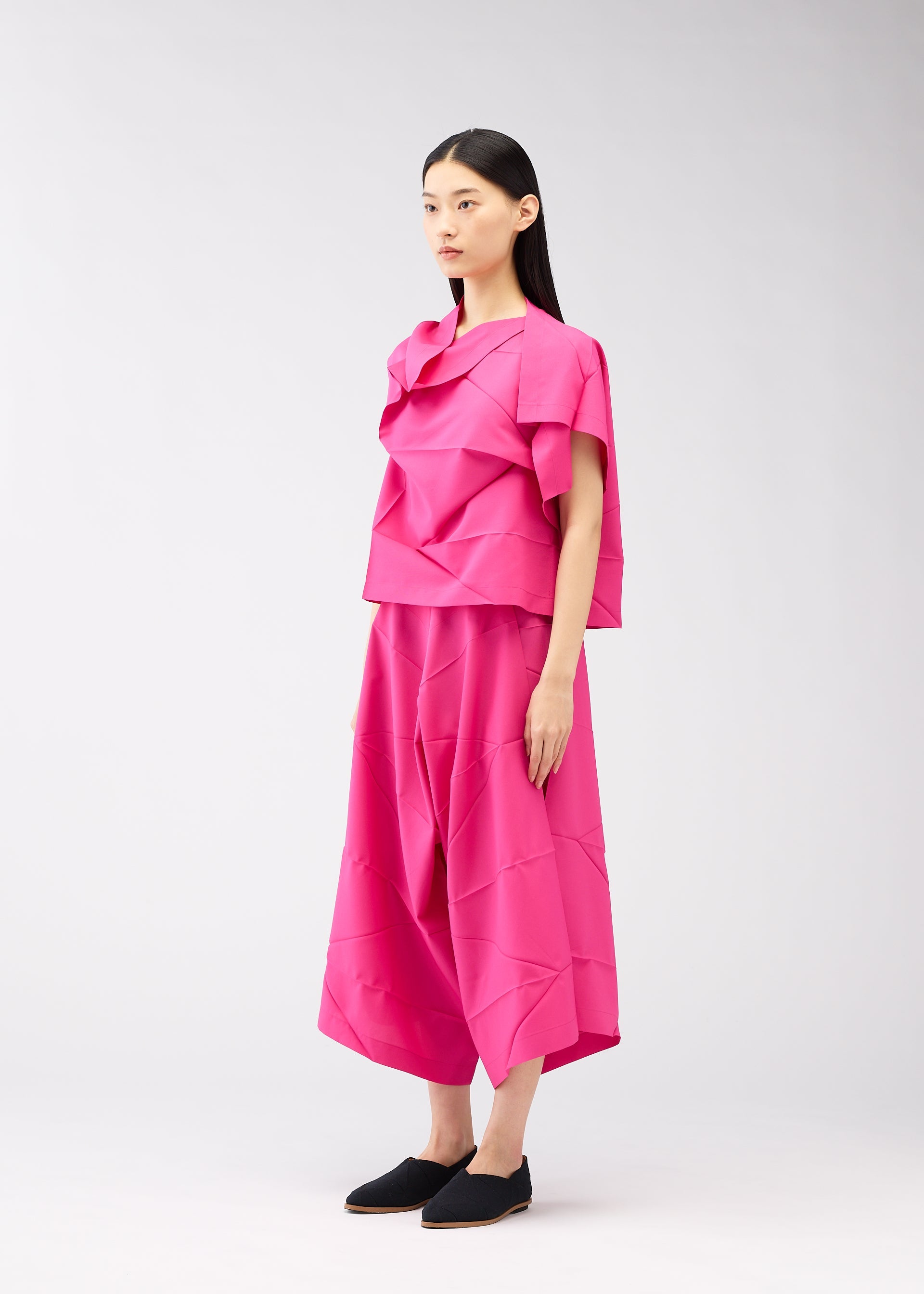 A model wears the 132 5. ISSEY MIYAKE NO.2 shirt.