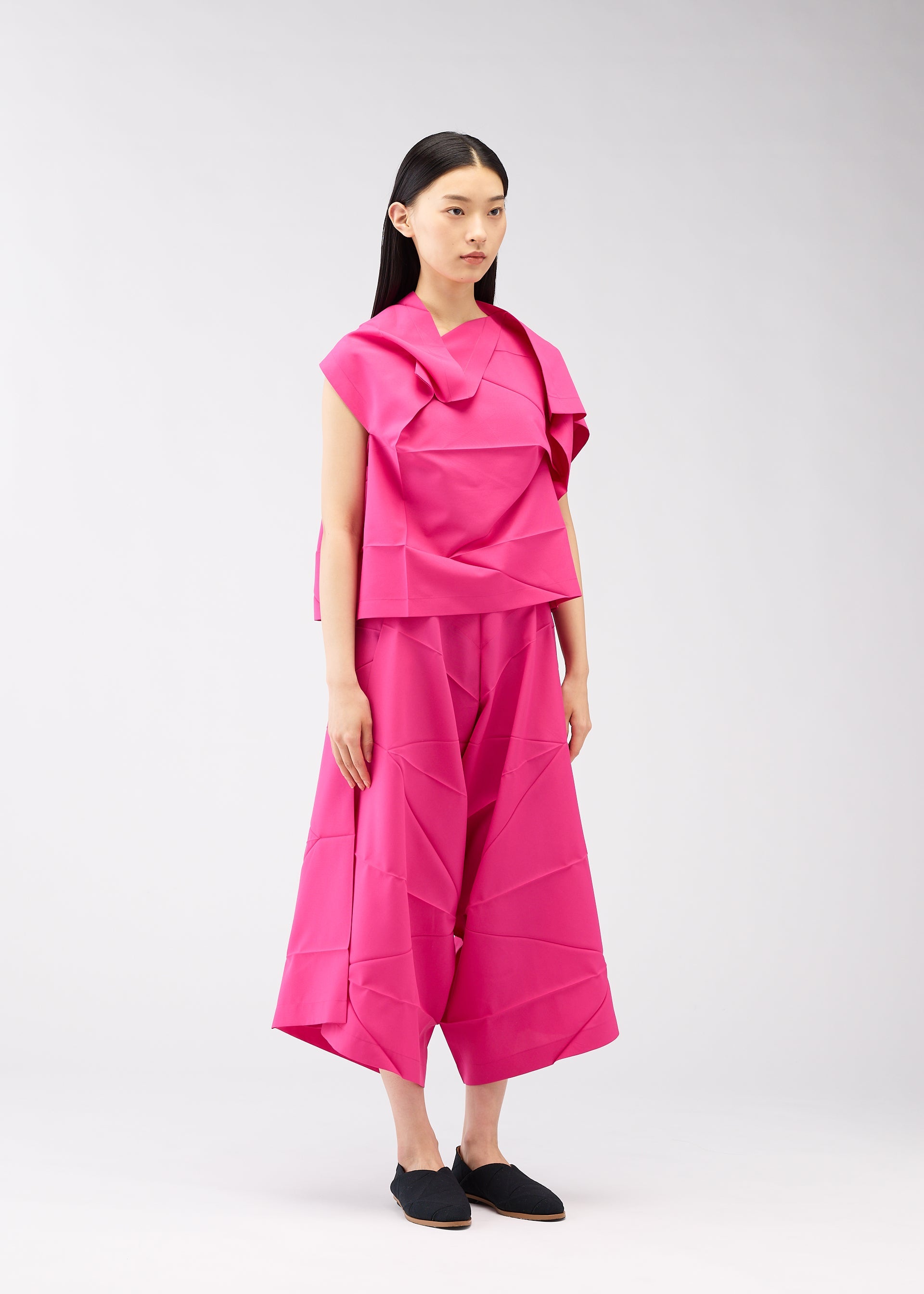 A model wears the 132 5. ISSEY MIYAKE NO.2 shirt.
