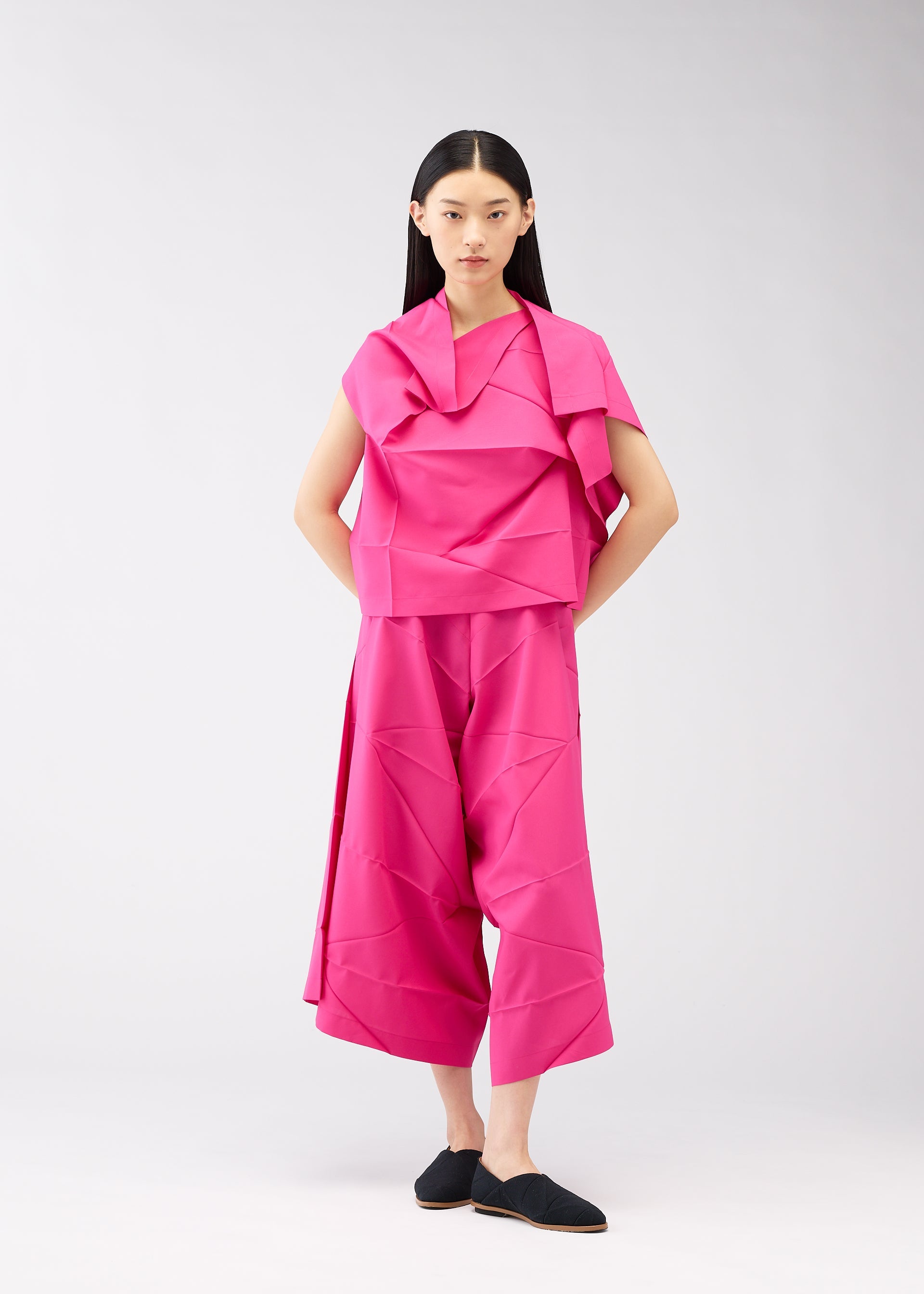 A model wears the 132 5. ISSEY MIYAKE NO.2 shirt.