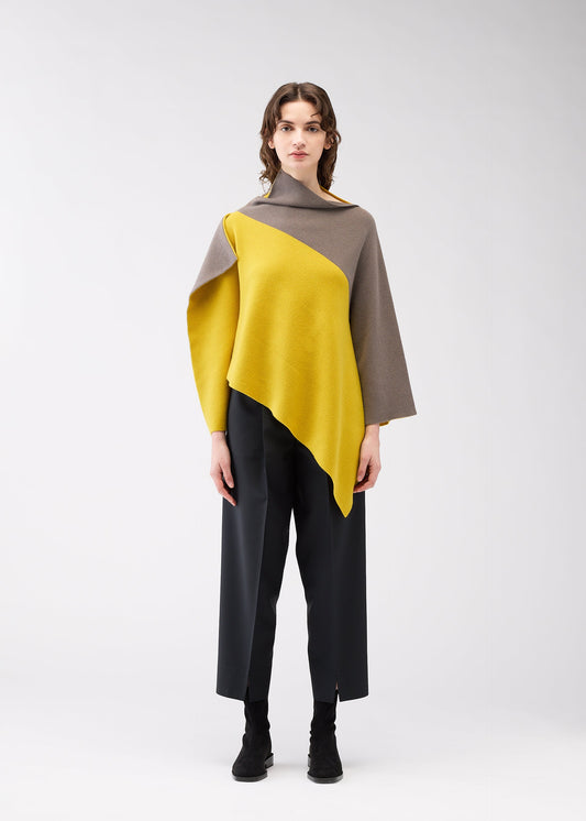 A model wears the 132 5. ISSEY MIYAKE POSITIONED KNIT top.