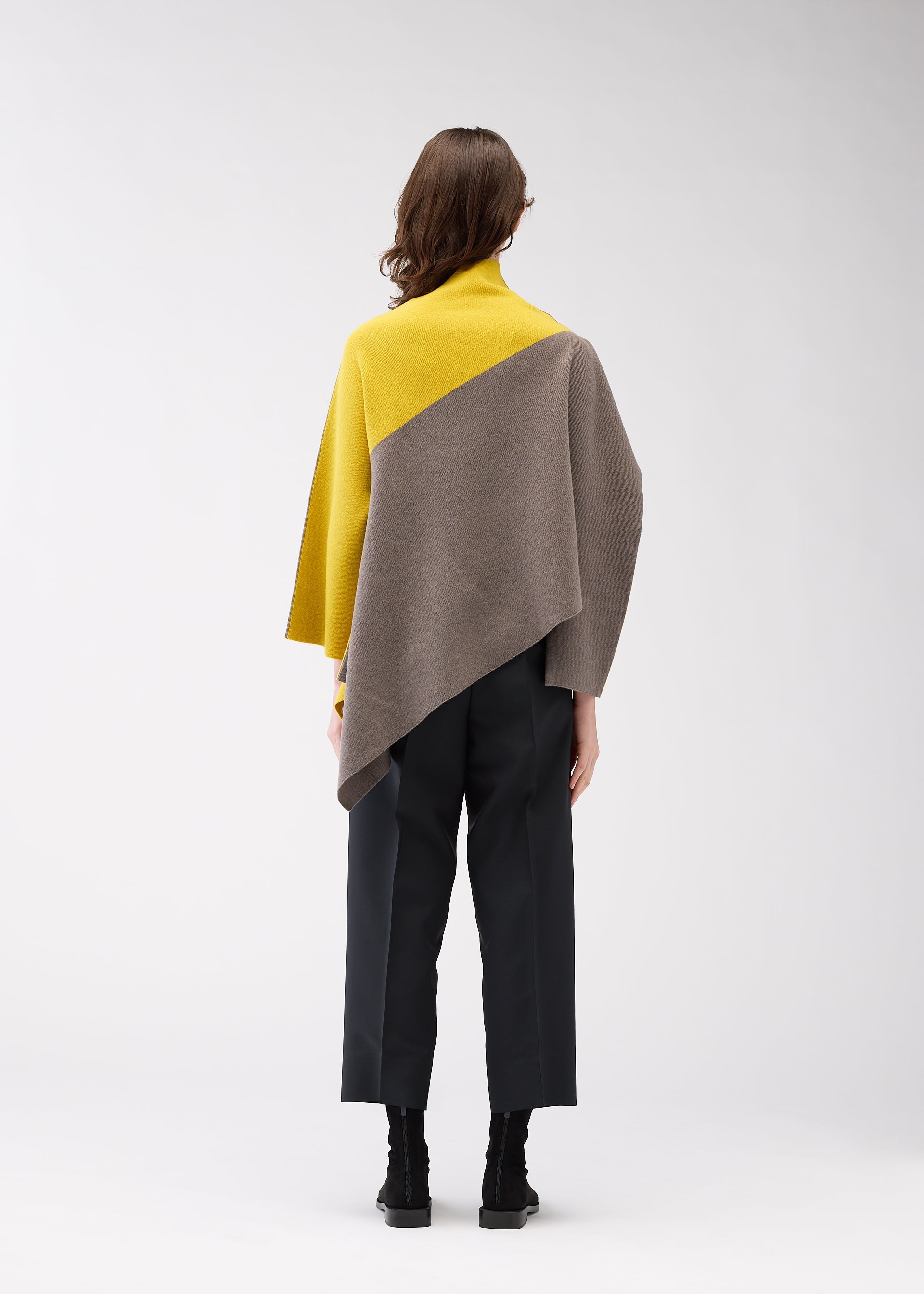 A model wears the 132 5. ISSEY MIYAKE POSITIONED KNIT top.