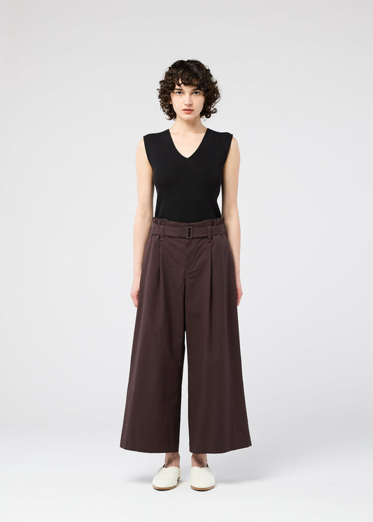 A model wears the 132 5. ISSEY MIYAKE WASHI STRETCH trousers.