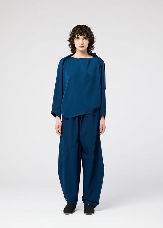 A model wears the 132 5. ISSEY MIYAKE PARALLEL WRAP shirt.